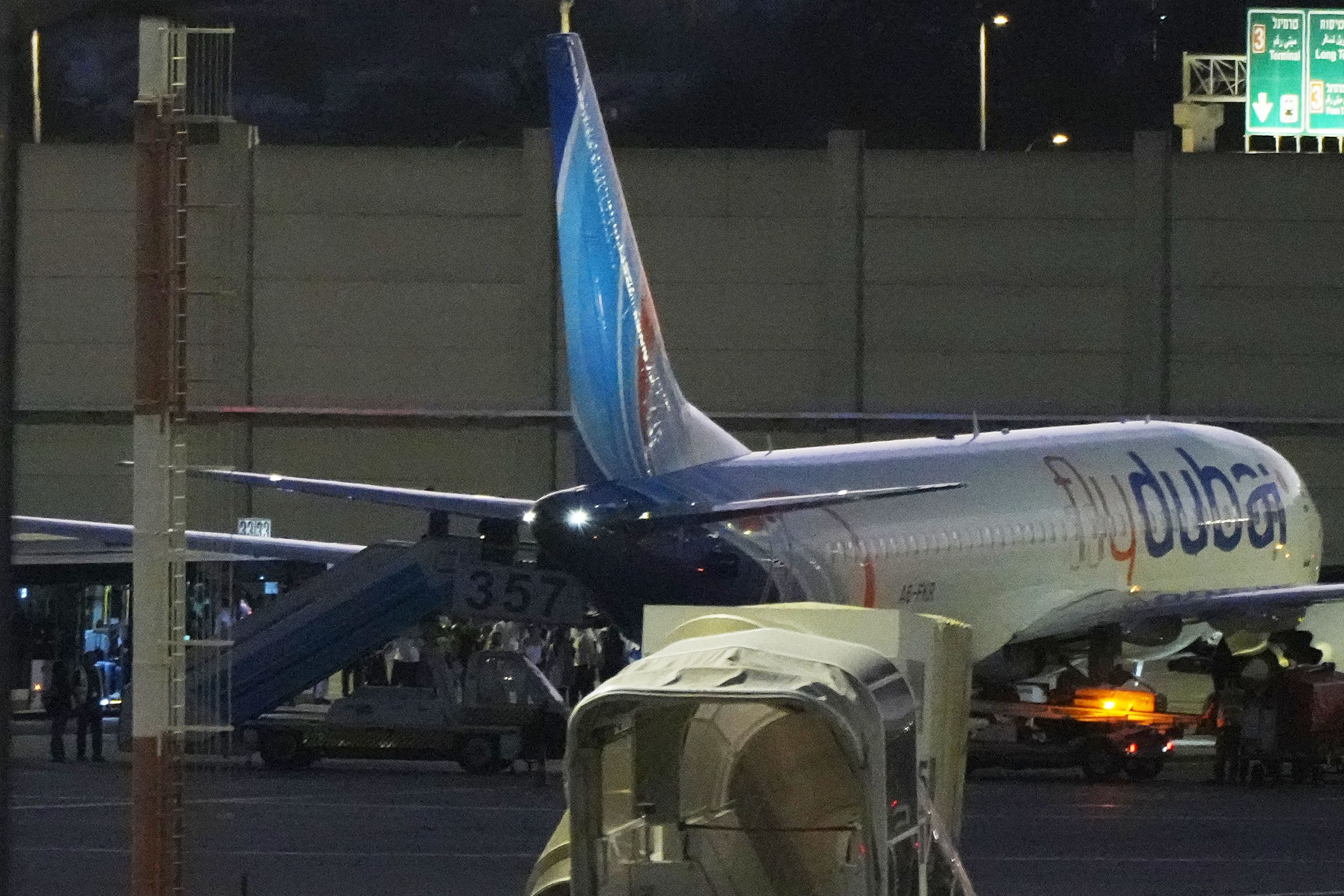 People disembark from a FlyDubai flight carrying Israeli passengers who had earlier been aboard another FlyDubai aircraft that made an emergency landing in Saudi Arabia on September 30.