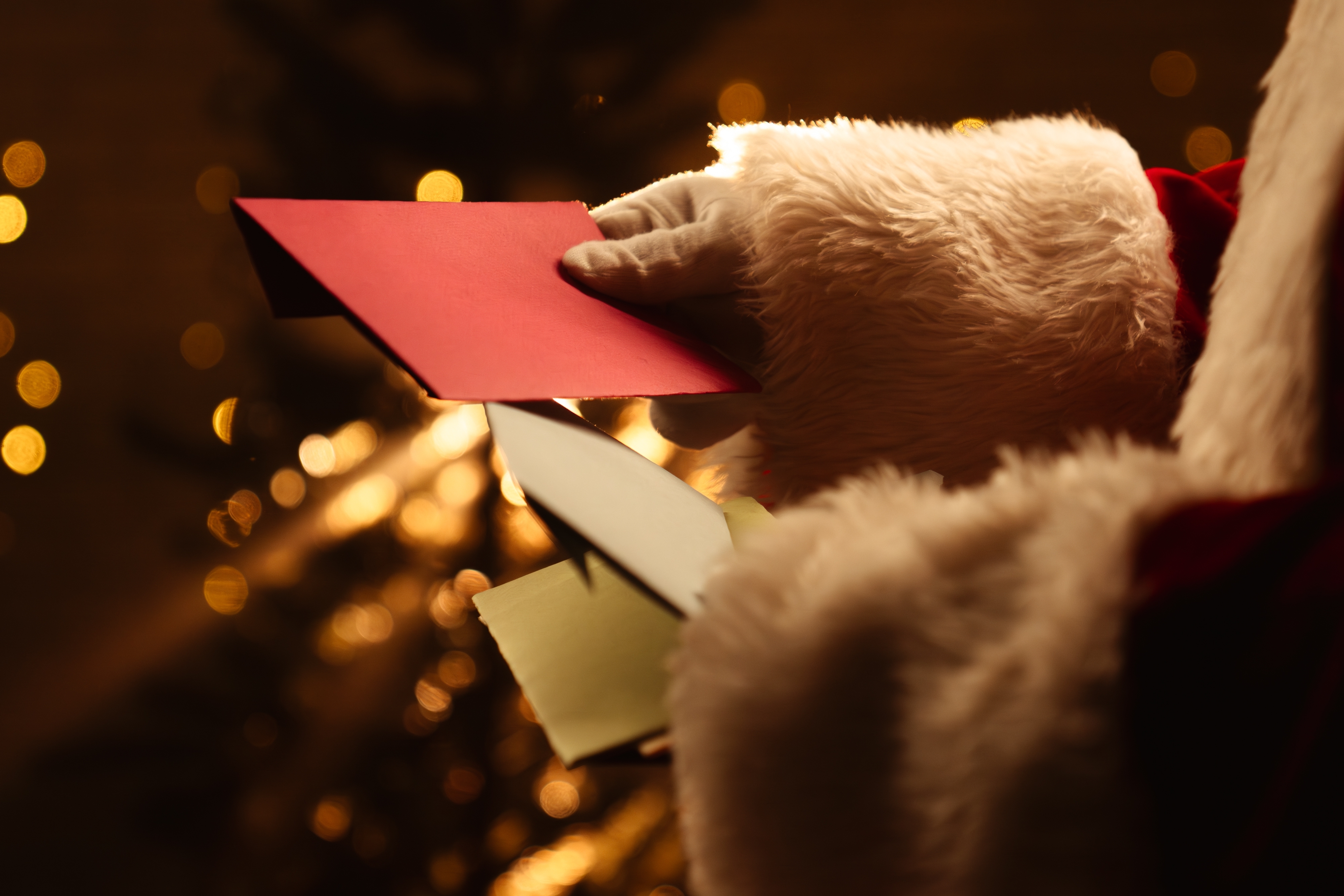 Santa Claus looking through letters from kids.
