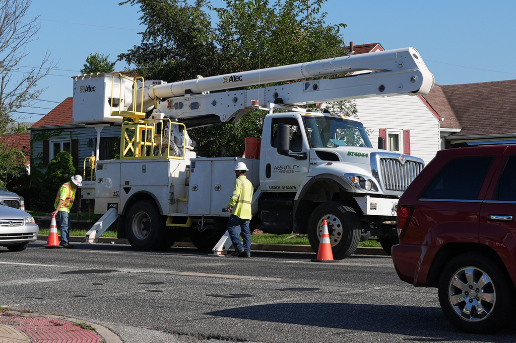 An electrical worker work power on the street for repair power in Gary, Ind, Thursday, Aug. 20, 2026, more than a week after a deadly storm passes through the area.