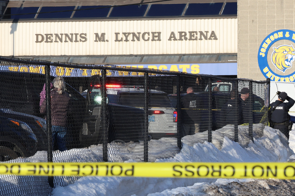 Police and ATF agents stand near the Lynch Arena in Pawtucket, R.I., after a shooting at the ice rink, Monday, Feb. 16, 2026.