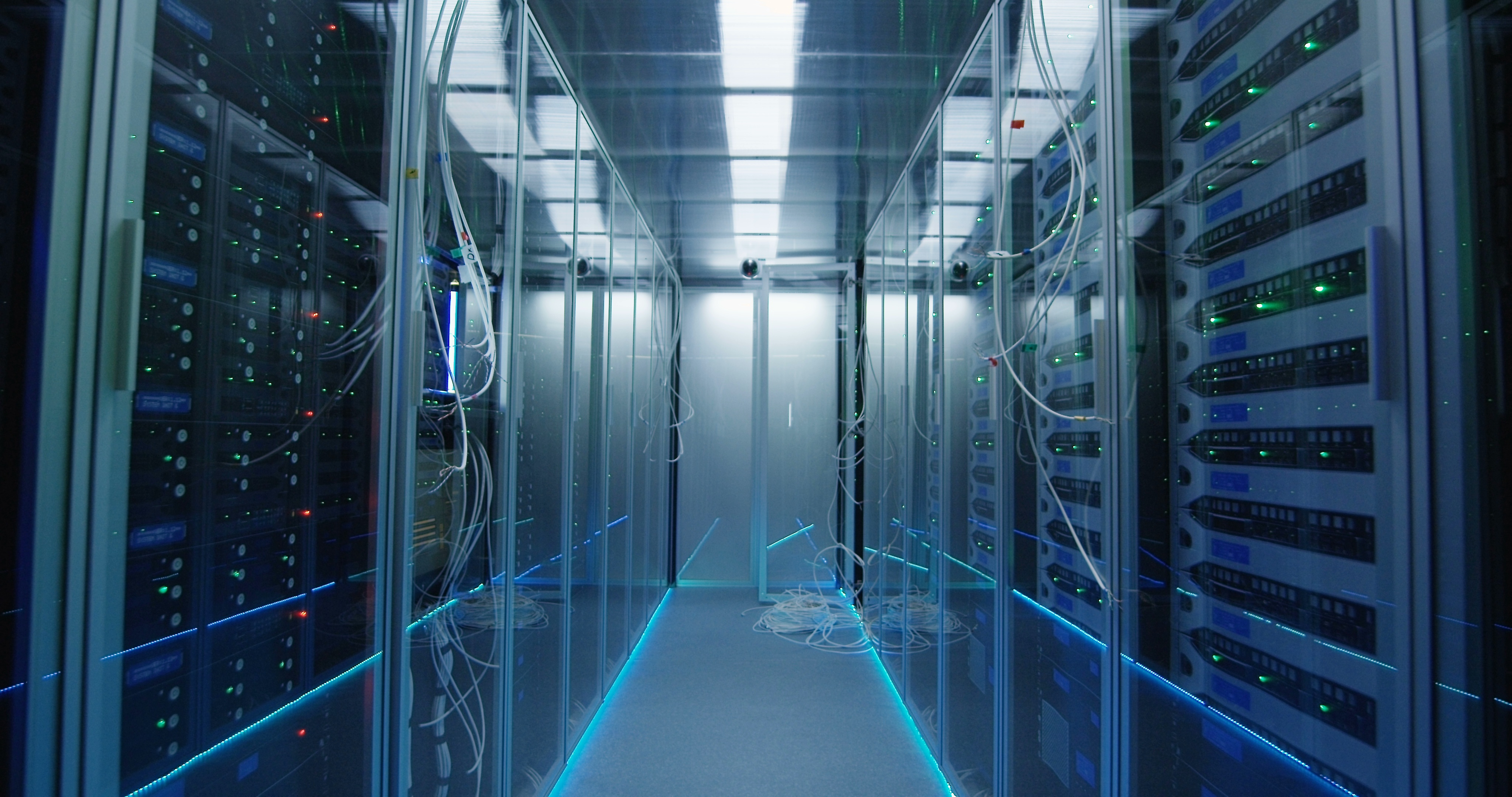 wide-movement-stabilized-shot-forward-of-an-empty-corridor-in-a-data-center-in-server--SBI-349440064.jpg