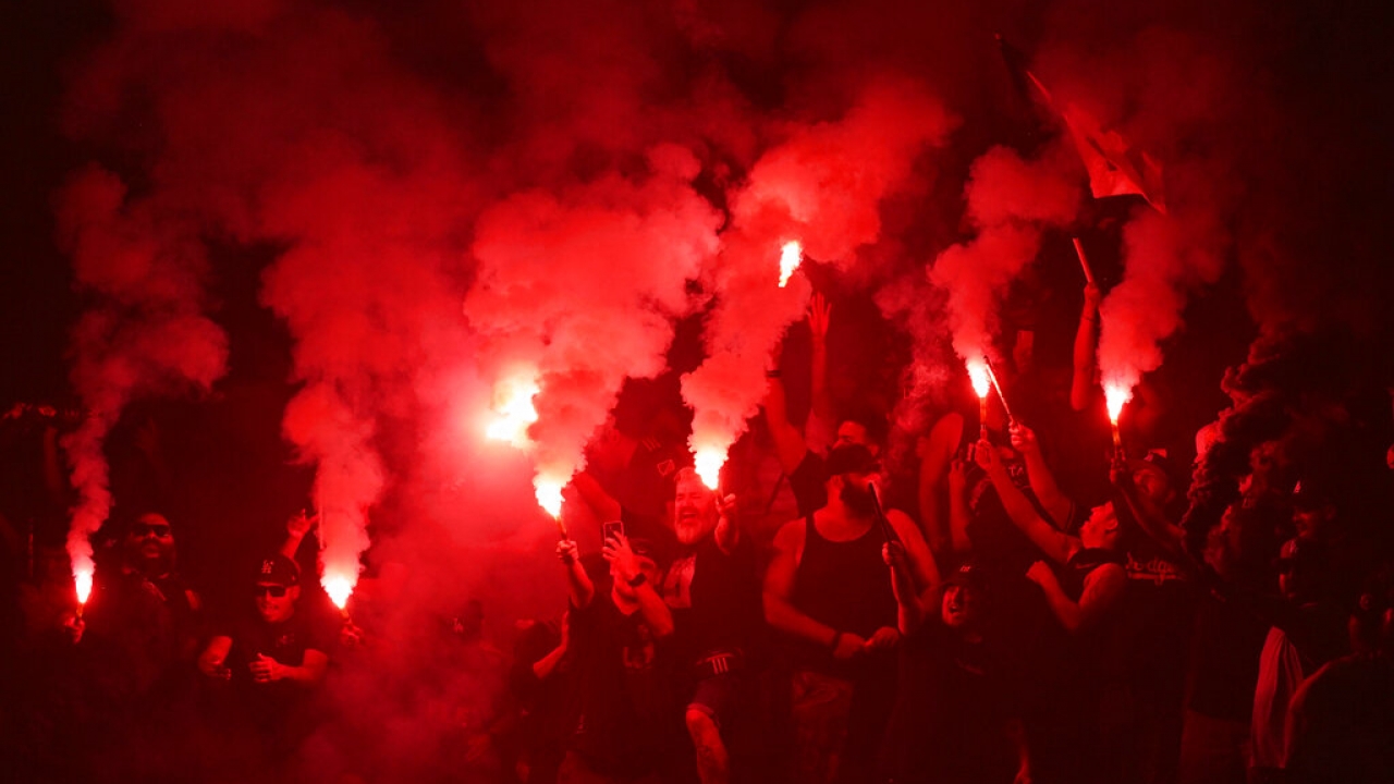 Fans light flares before an LAFC game.