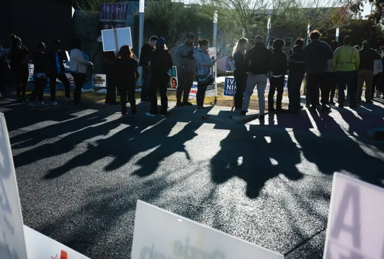 Voters wait in line to cast their ballots on Election Day at the Esperanza Acosta Memorial Library in El Paso on Nov. 5, 2024.