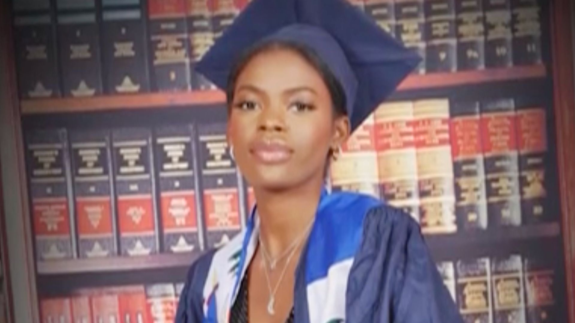 This photo provided by Whitney shows her in a cap and gown posing after graduation.
