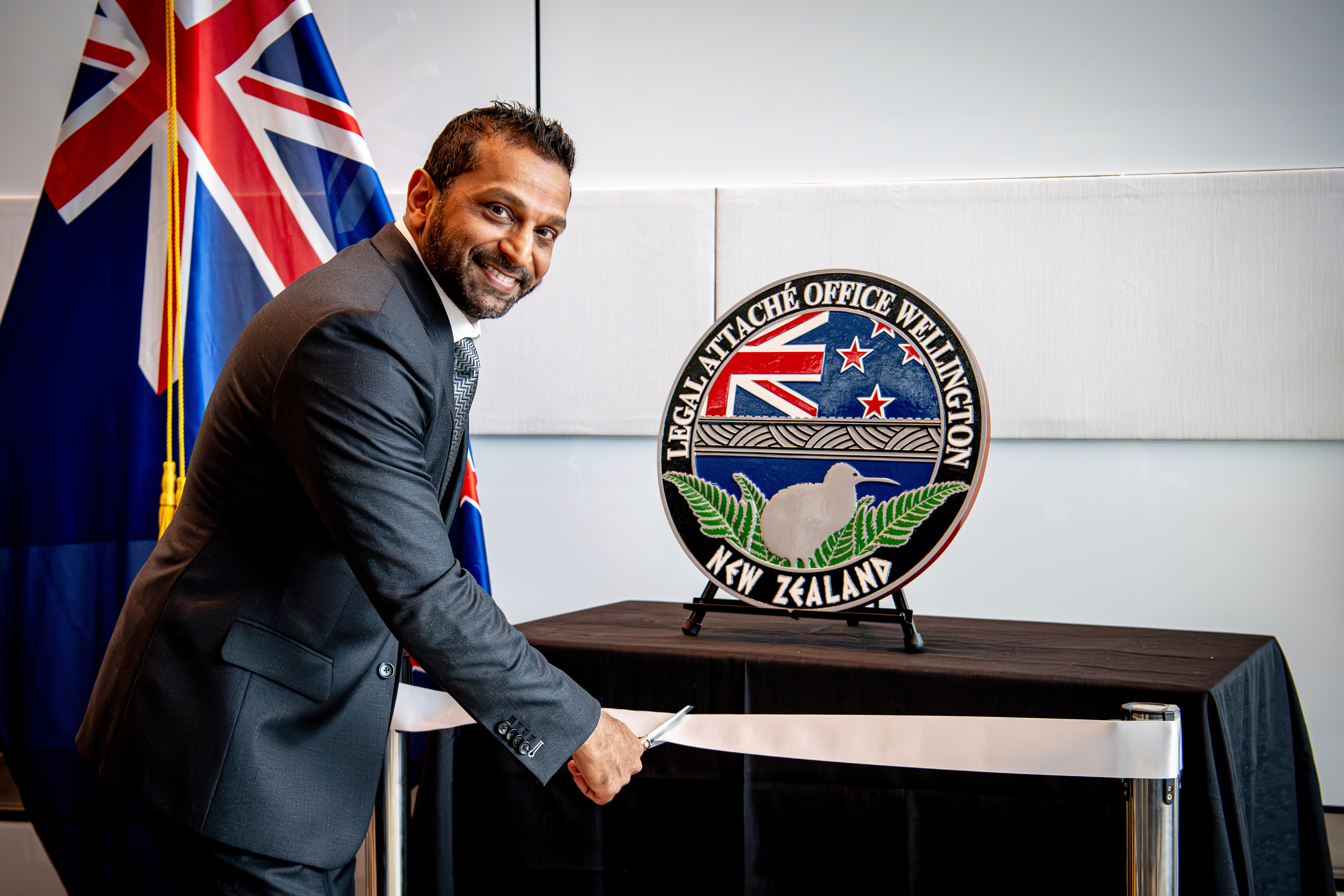 In this photo released by the US Embassy in Wellington, New Zealand, FBI Director Kash Patel cuts the ribbon at the official opening of the FBI office in Wellington, New Zealand, July 31, 2025.