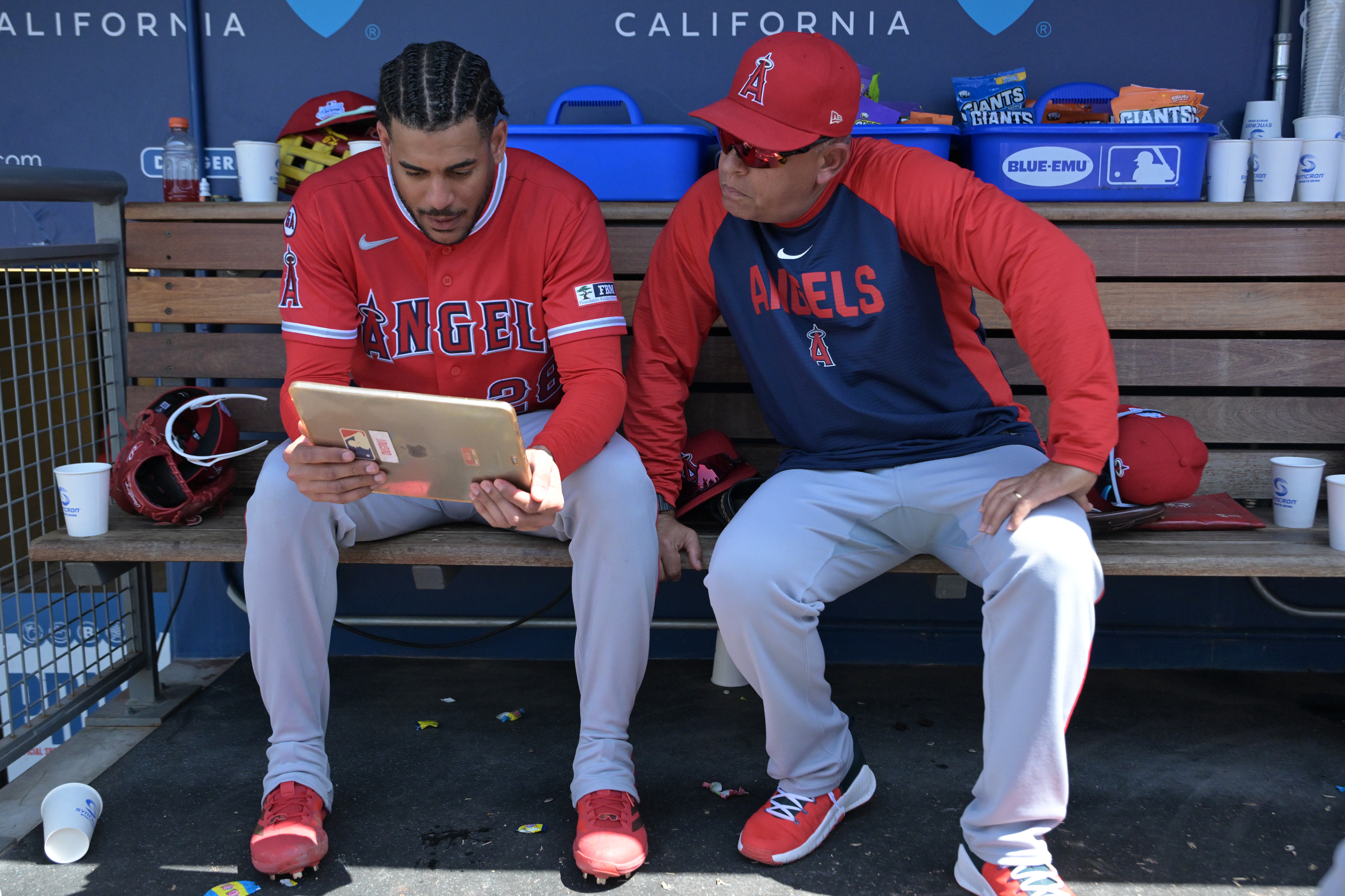 FILE - Los Angeles Angels' Jose Siri, left, looks at an iPad in the dugout with Angels' assistant hitting coach Jobel Jiménez during a baseball game against the Los Angeles Dodgers, June 7, 2026, in Los Angeles. 