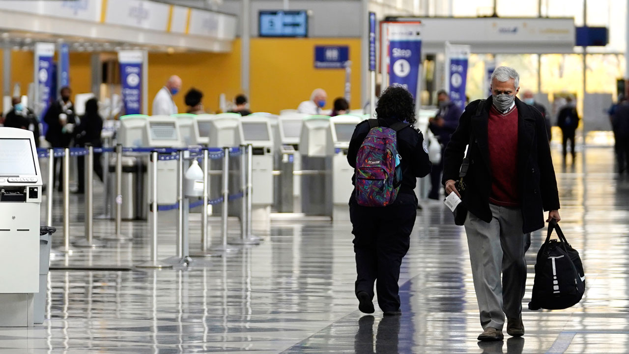 Travelers walk through Terminal 1 at O'Hare International Airport