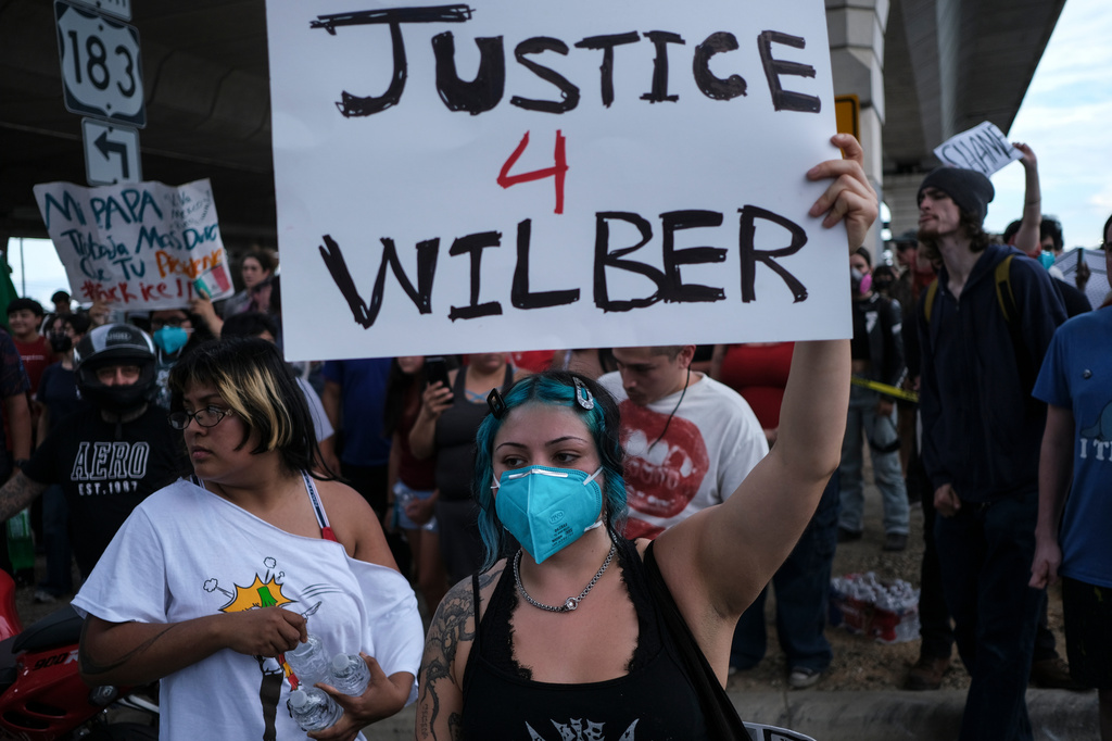 People speak during a demonstration where a man was shot in his vehicle by an ICE officer, Sunday, Sept. 20, 2026, in Austin, Texas.