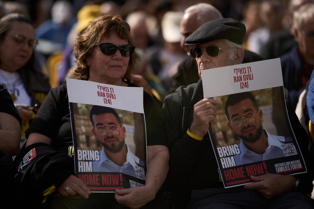 People hold signs with a photo of Ran Gvili, who was killed while fighting Hamas militants during the Oct. 7, 2023 attack and whose body has been held in Gaza ever since, during a rally calling for his return in Tel Aviv, Israel, Friday, Jan. 23, 2026. \