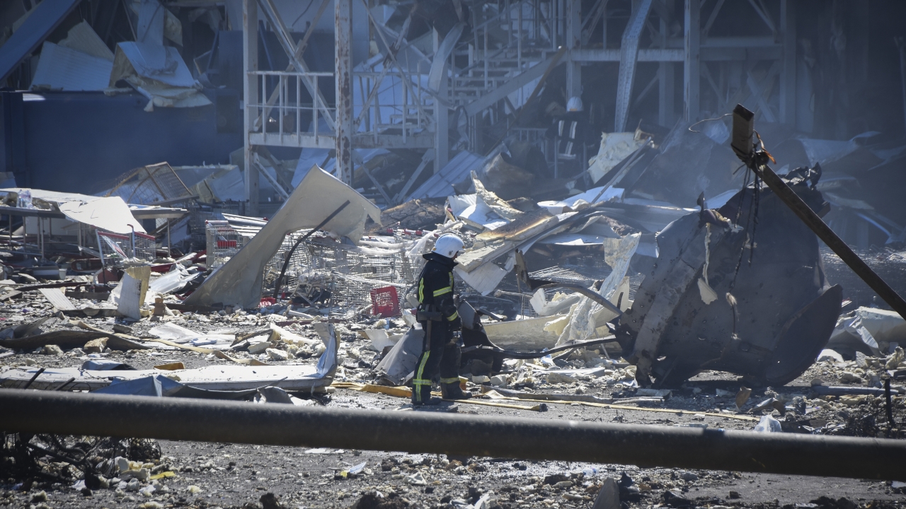 A Ukrainian firefighter works near a destroyed building on the outskirts of Odesa, Ukraine