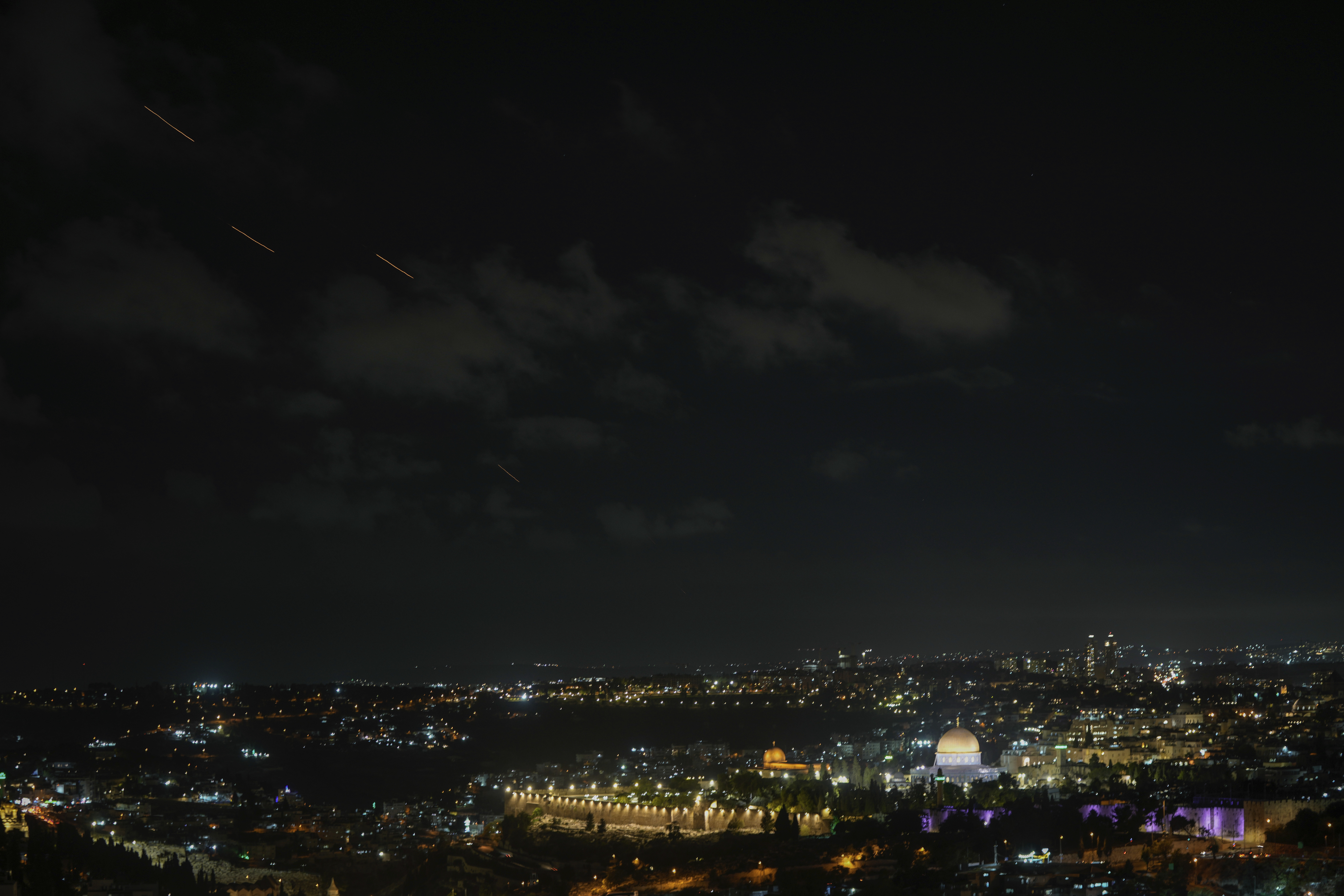 Projectiles fly through the sky over Jerusalem