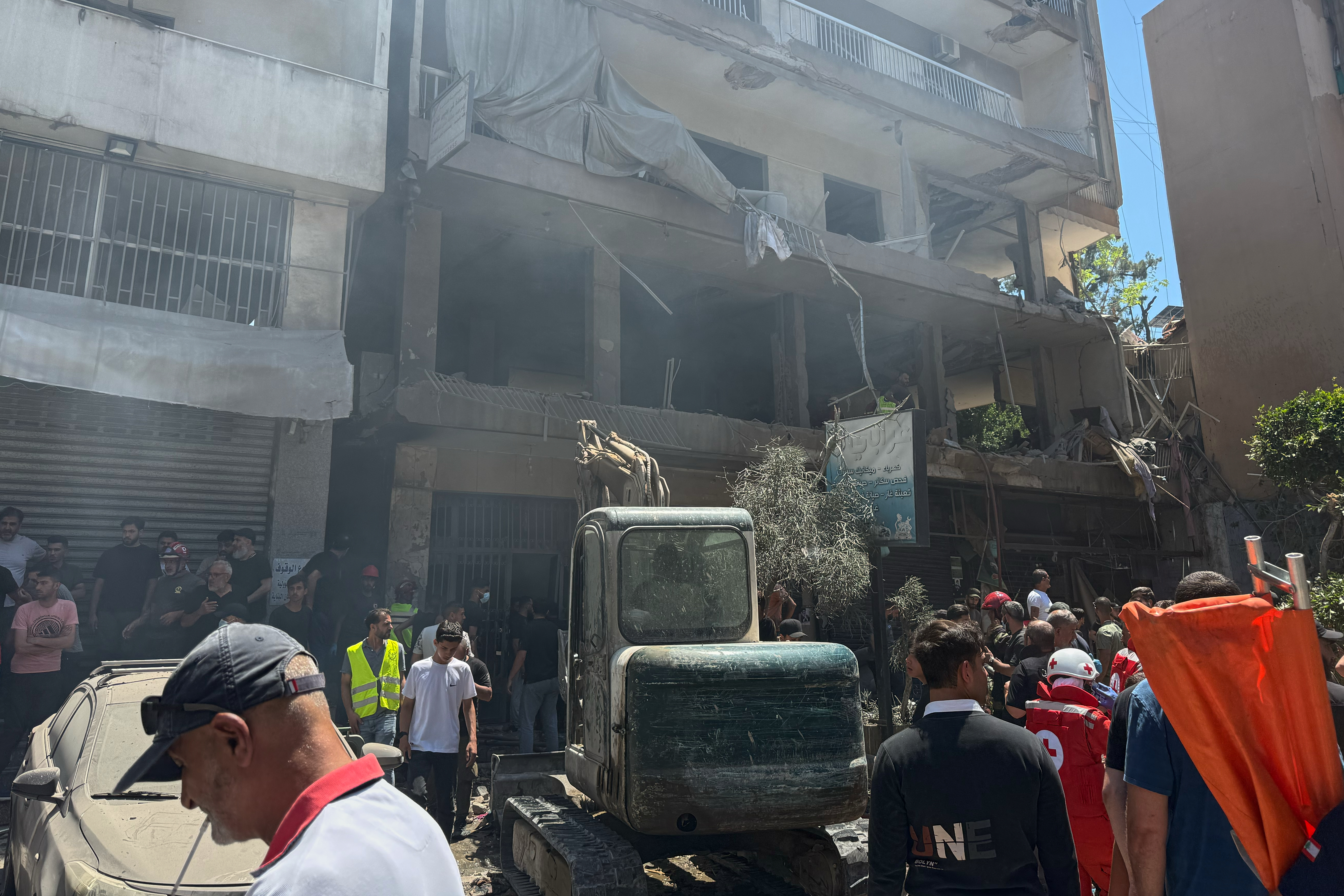 People gather at the site of an Israeli airstrike that struck an apartment in Dahiyeh, Beirut's southern suburbs, Lebanon, Sunday, June 14, 2026.