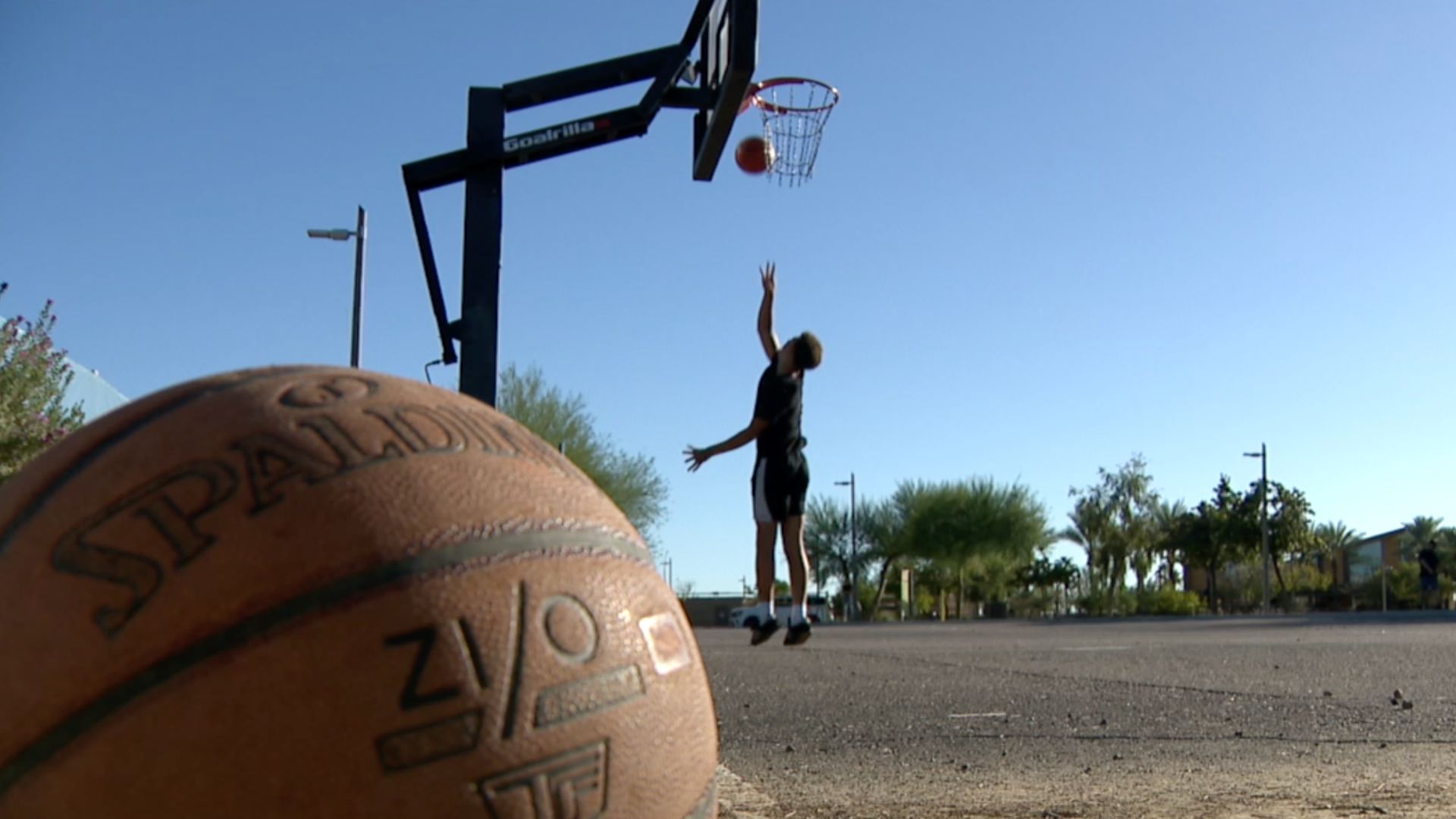 Laker Jackson going for a layup on a basketball court.