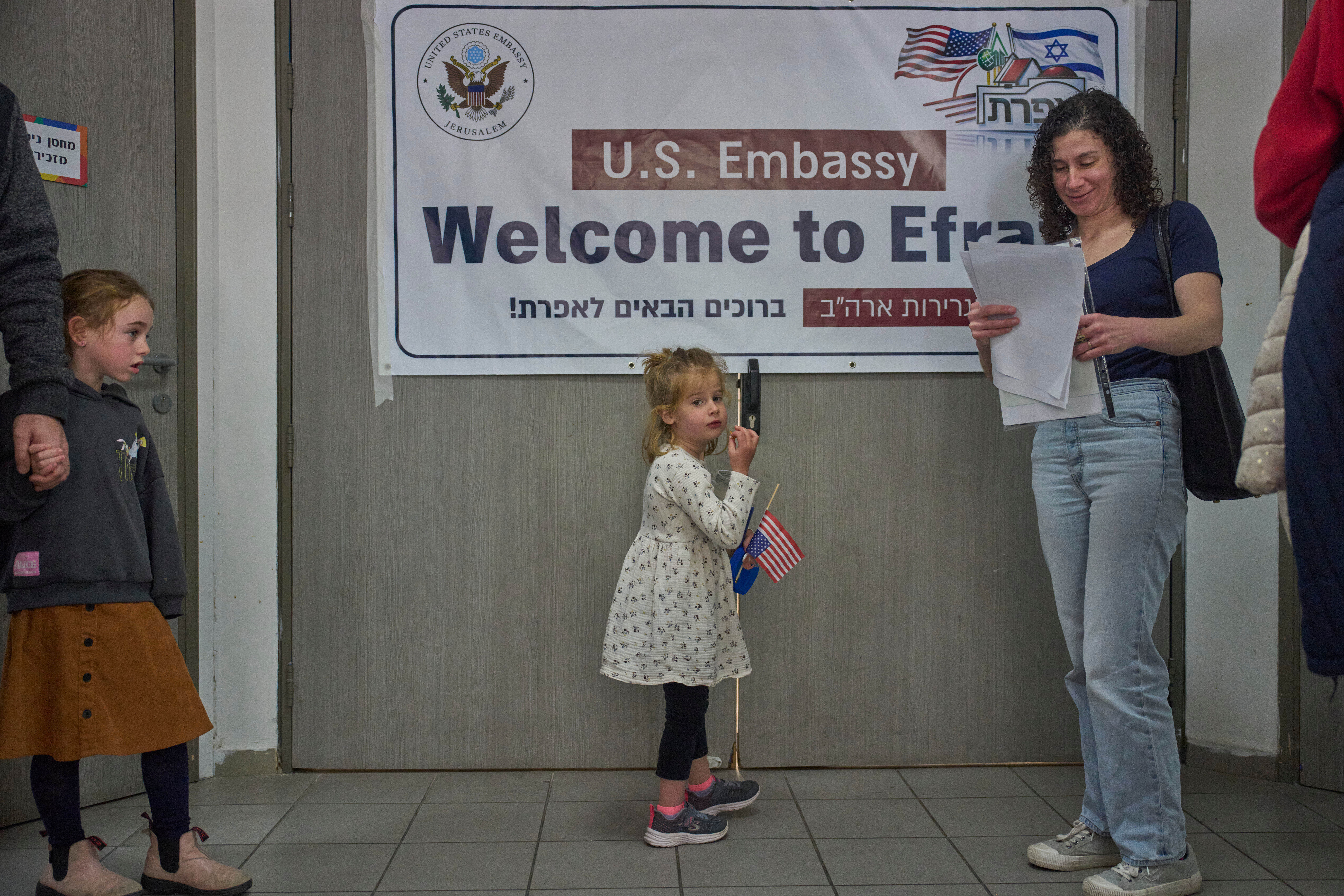 Kayla Friedson, center, and her mother wait for their turn to receive consular services from U.S. embassy officials at the Jewish settlement of Efrat in the West Bank, Friday, Feb.27, 2026. 