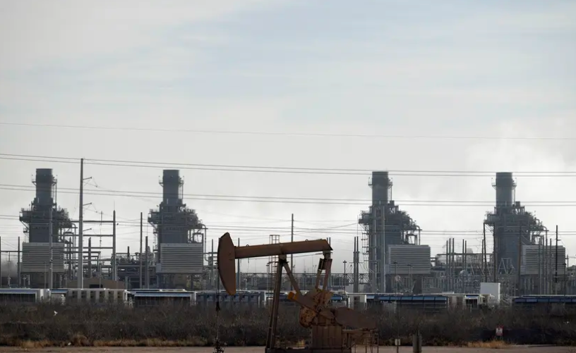 A pump jack operates near a gas turbine power plant in the Permian Basin oil field outside of Odessa on Feb. 18, 2025.