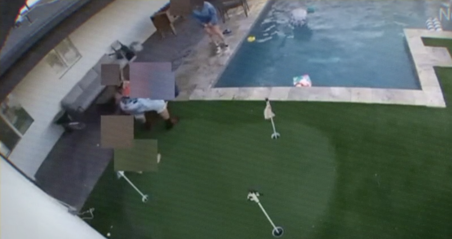 This screenshot from surveillance video shows the moment family members rush to save a young child from a non-fatal drowning in a vacation home pool.