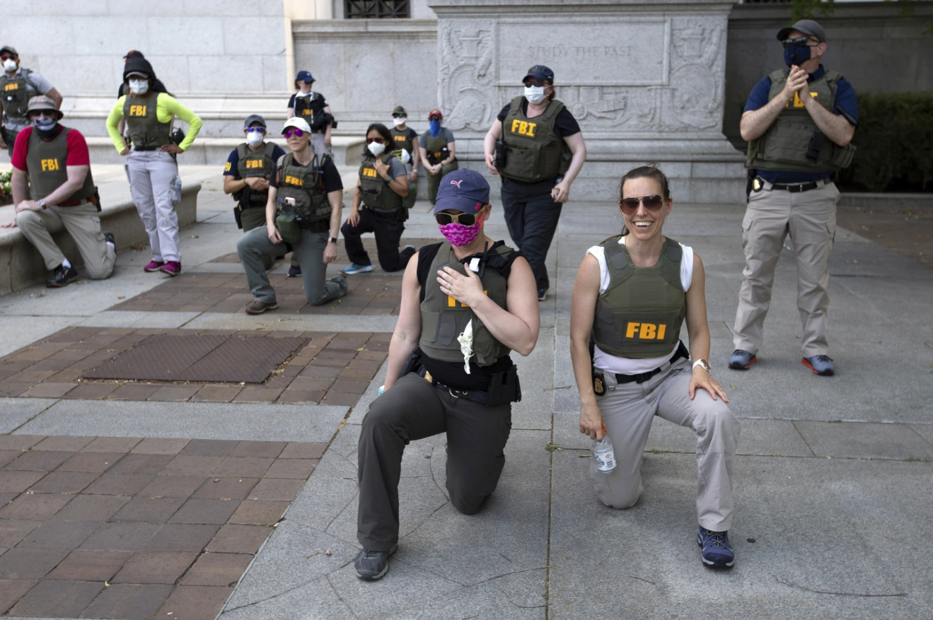FBI officers take a knee with demonstrators
