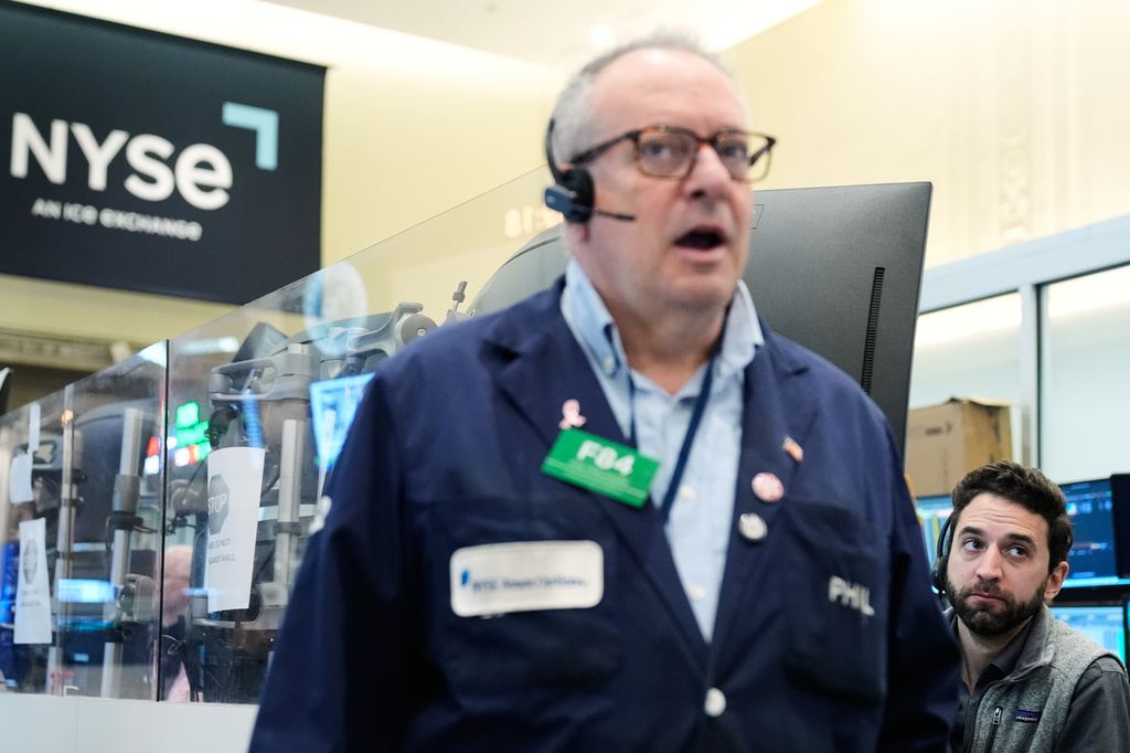People work on the floor at the New York Stock Exchange in New York, Monday, April 13, 2026.