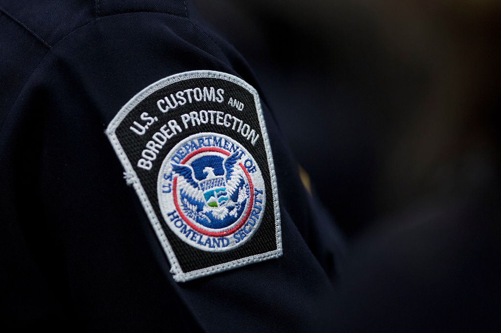 A customs agent wears a patch for the U.S. Customs and Border Protection agency.