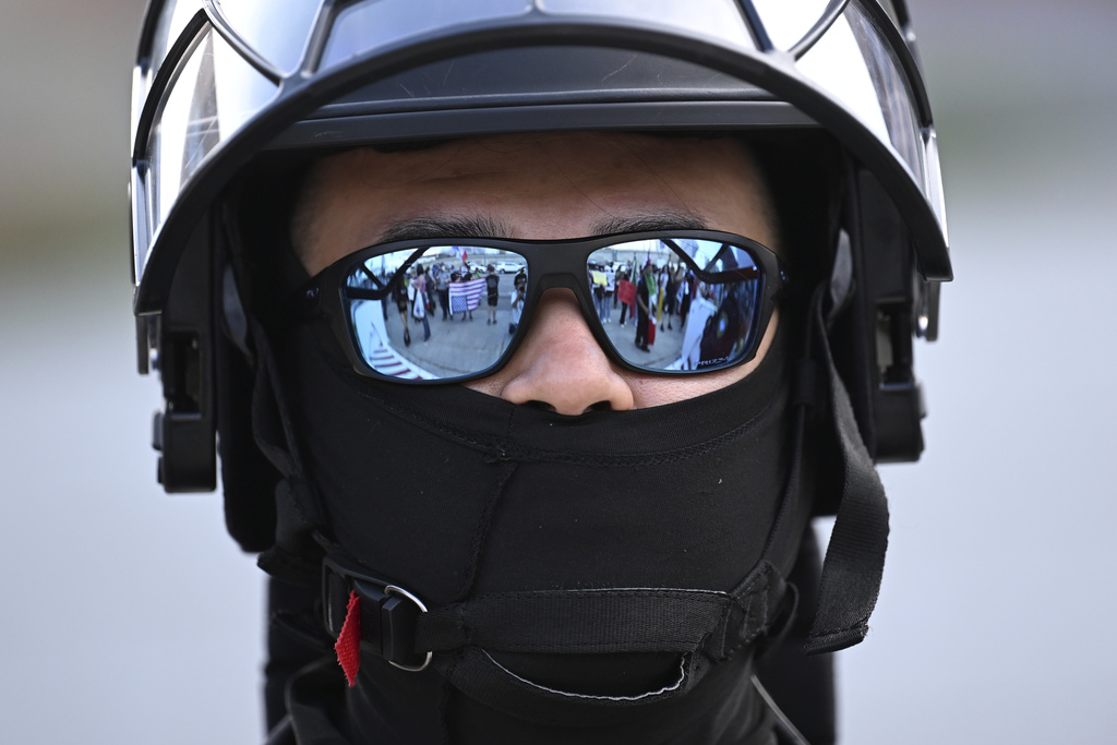 A U.S. Customs and Border Patrol agent looks on during a protest outside the Federal Building in Los Angeles.