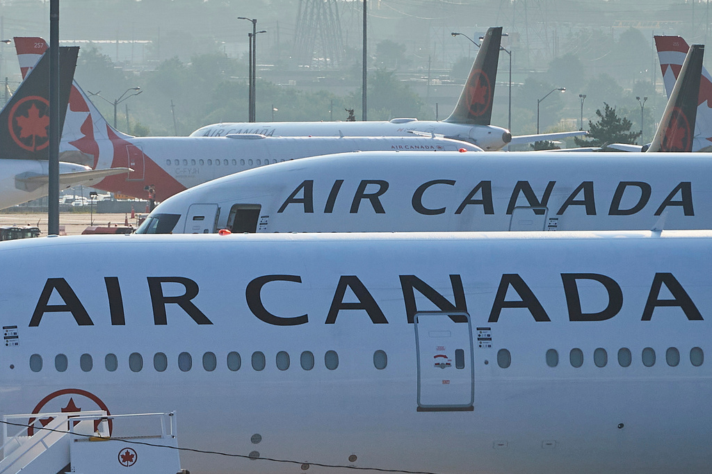 FILE - Air Canada planes sit on the runway at Pearson International Airport in Toronto on Aug. 16, 2025.