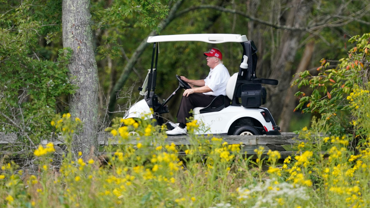 Former President Donald Trump rides around his golf course at Trump National Golf Club in Sterling, Va., Monday, Sept. 12, 2022. 