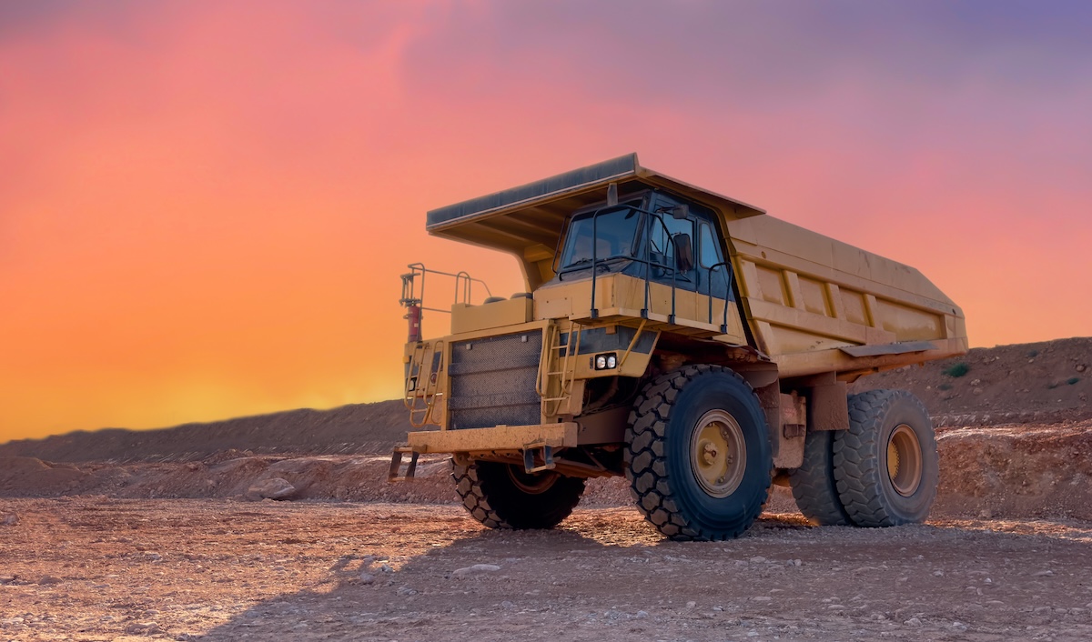 Mining truck in open-pit mining. Construction equipment on soil transport. Haul truck at construction site.