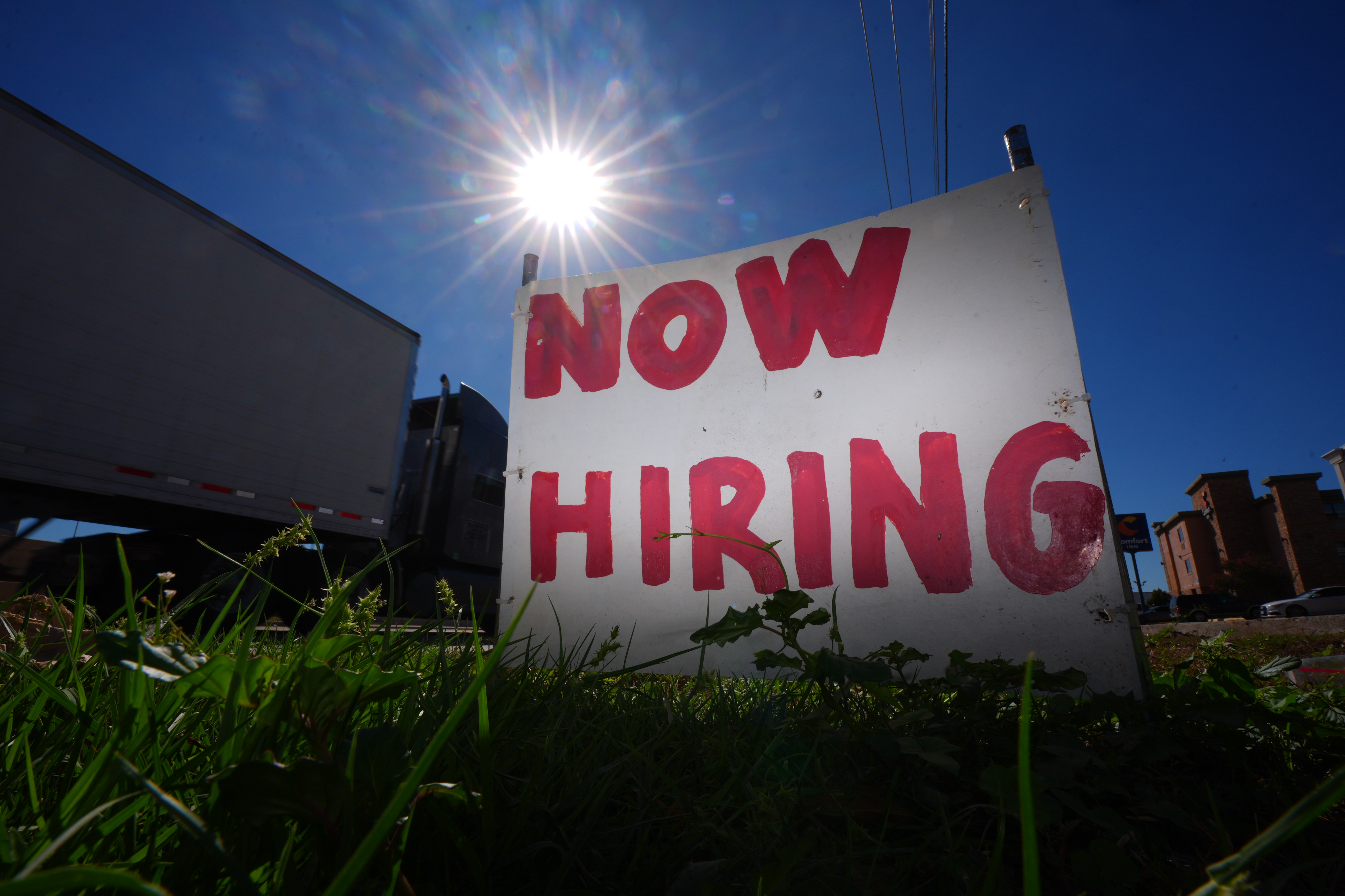 A "now hiring" sign.