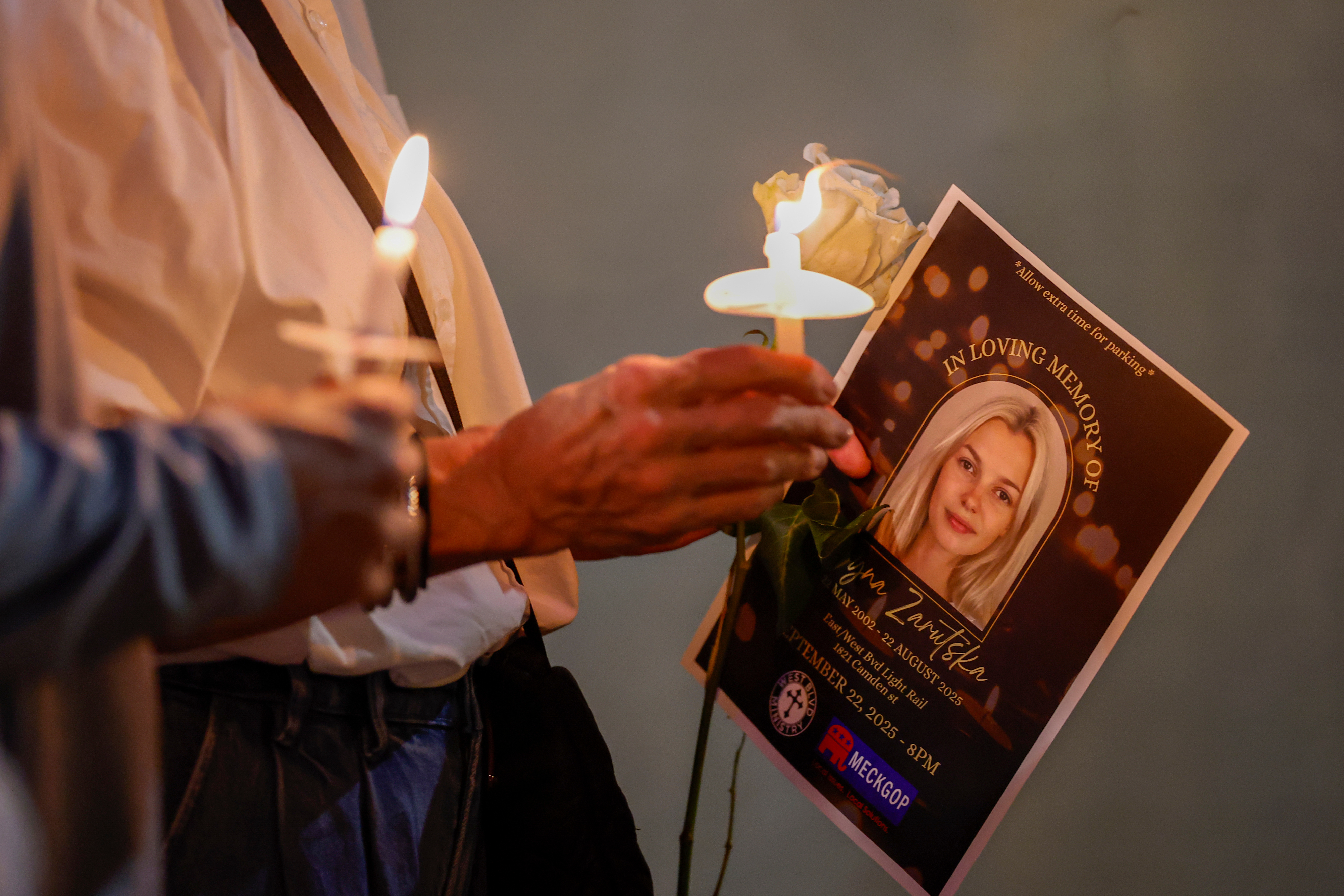 Community members hold candles as they gather for a vigil honoring the life of Iryna Zarutska, who was fatally stabbed on a commuter train last month, Monday, Sept. 22, 2025, in Charlotte, N.C.
