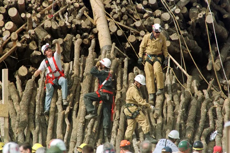 Rescue workers dig through a bonfire structure that collapsed Nov. 18, 1999, on the Texas A&M campus in College Station, killing 12 people and injuring several others. The bonfire, made of thousands of logs, was a longtime annual tradition ahead of Texas A&M/UT-Austin football games but was suspended after the 1999 tragedy.