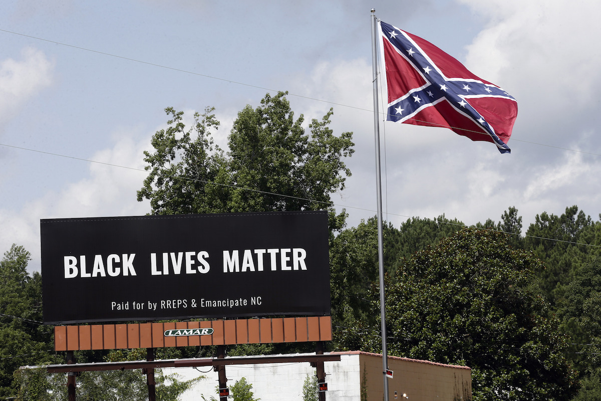 Black Lives Matter billboard placed next to Confederate flag