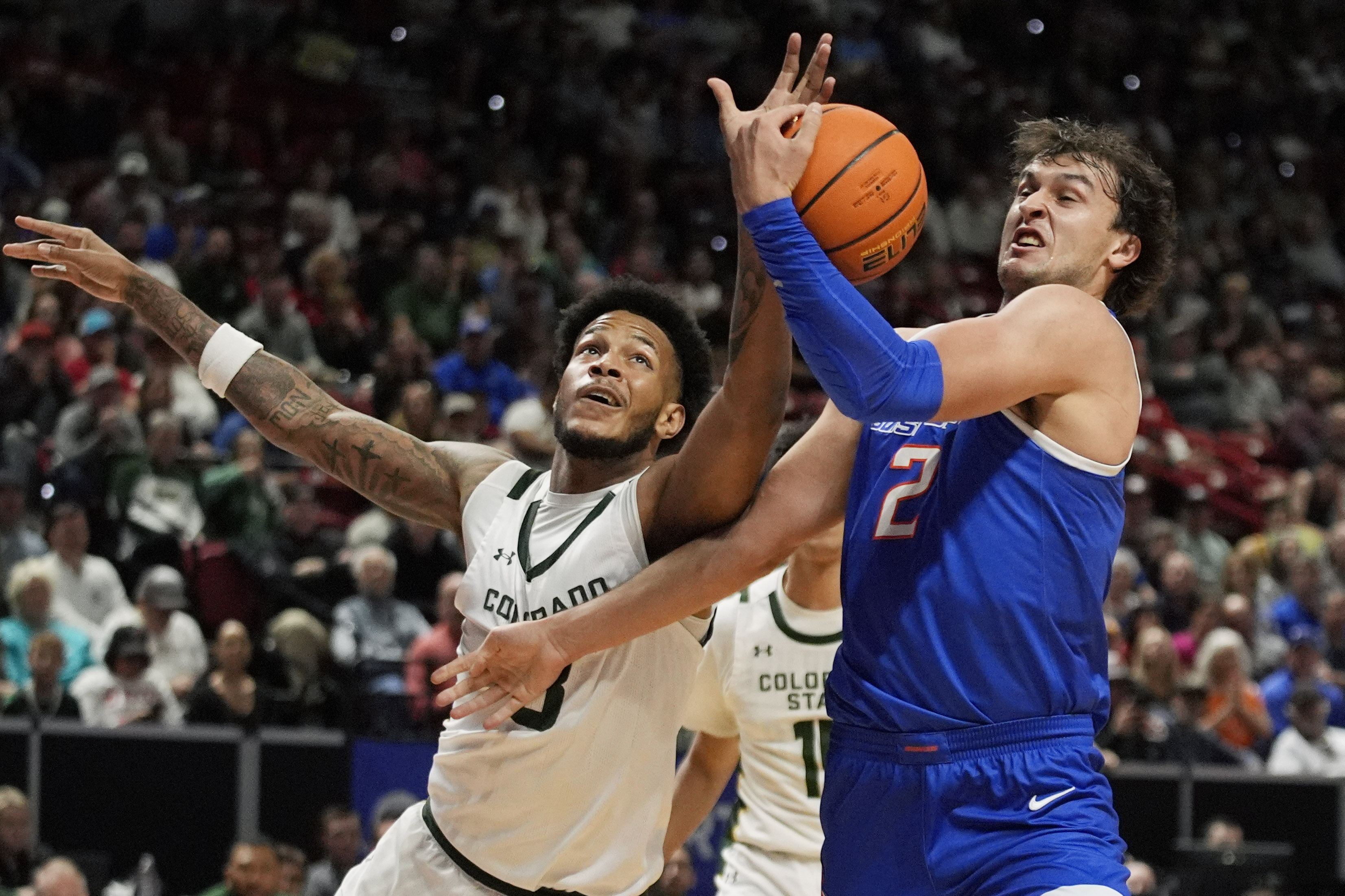 Boise State forward Tyson Degenhart (2) grabs a rebound over Colorado State forward Jaylen Crocker-Johnson (8) during the first half of an NCAA college basketball championship game at the Mountain West Conference tournament Saturday,