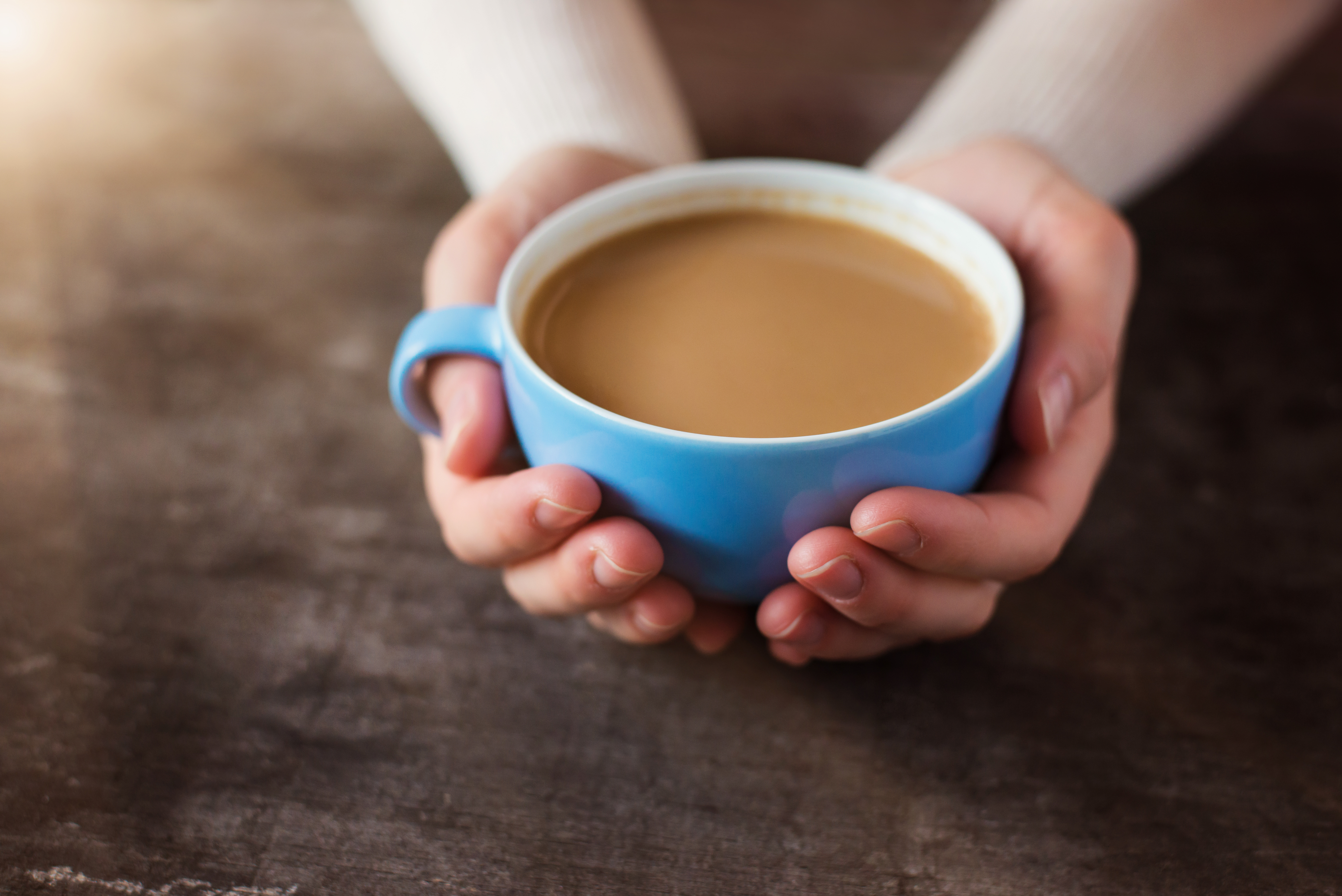 Unrecognizable woman with cup of coffee