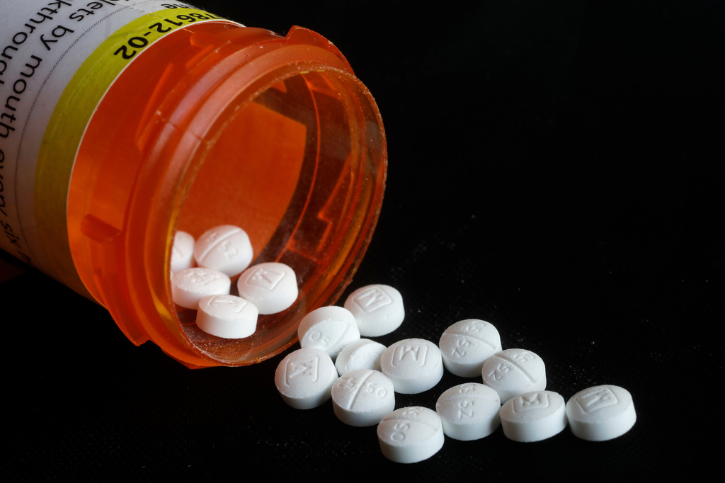 Pills spill in an arrangement photo of prescription Oxycodone.