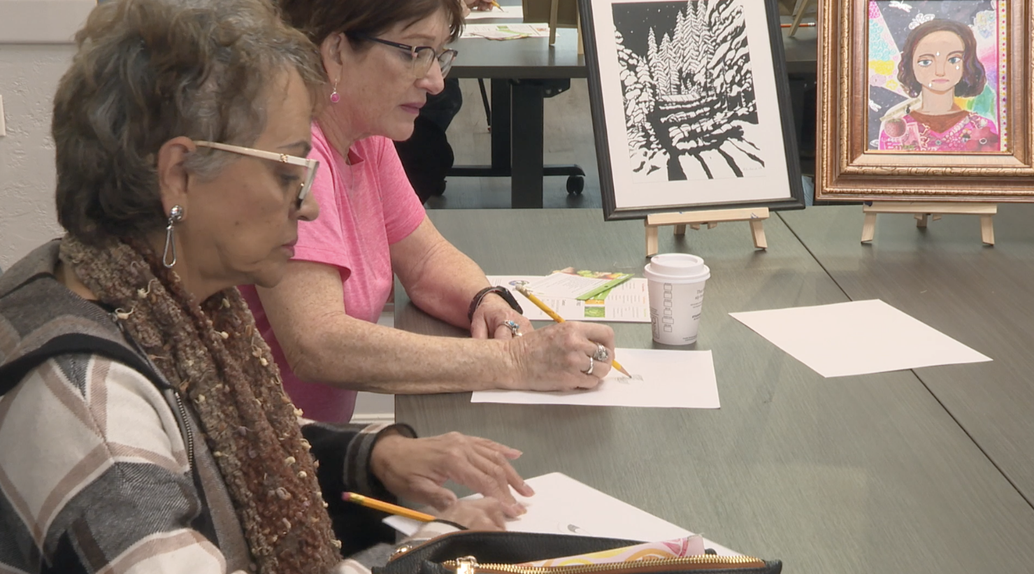 People take a quick art lesson at the Culture for Change Foundation grand opening on Friday, Feb. 7, 2025