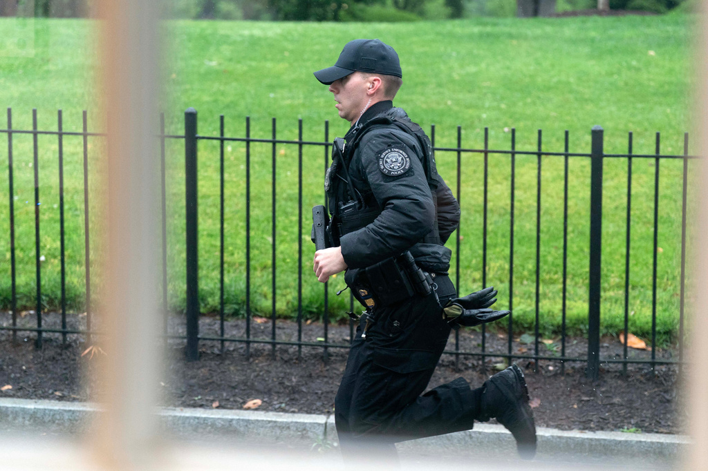 A Secret service officer runs at the White House, Saturday, May 23, 2026, in Washington. 