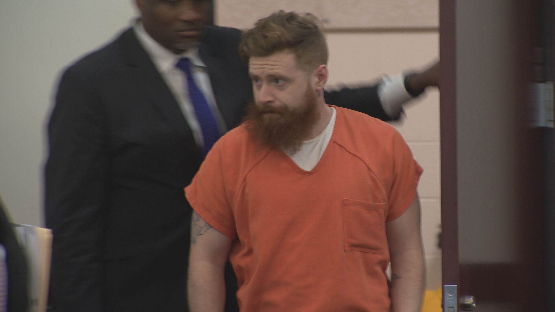 Ryan McCann enters courtroom.jpeg