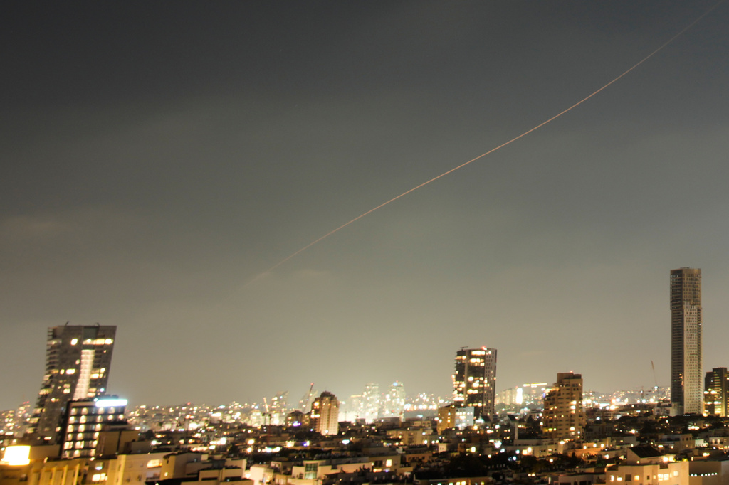 A projectile streaks through the sky over central Israel during an Iranian missile attack, Sunday, June 7, 2026. 