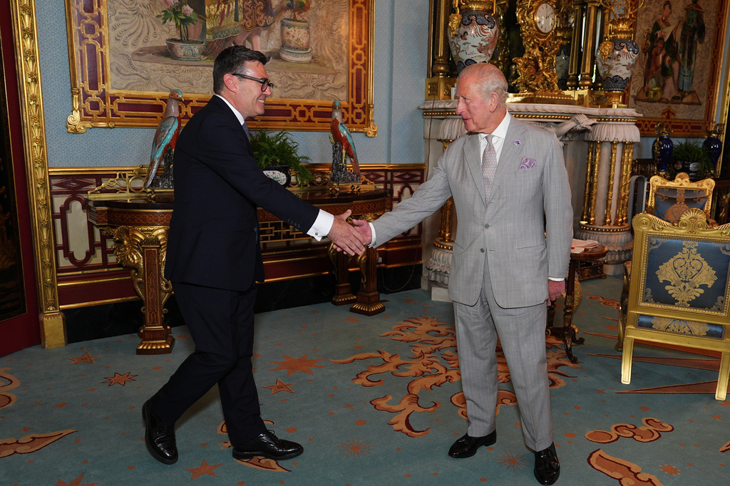 Britain's King Charles III welcomes Andy Burnham, left, during an audience at Buckingham Palace, London, where he invited the leader of the Labour Party to become Prime Minister and form a new government, Monday July 20, 2026. 