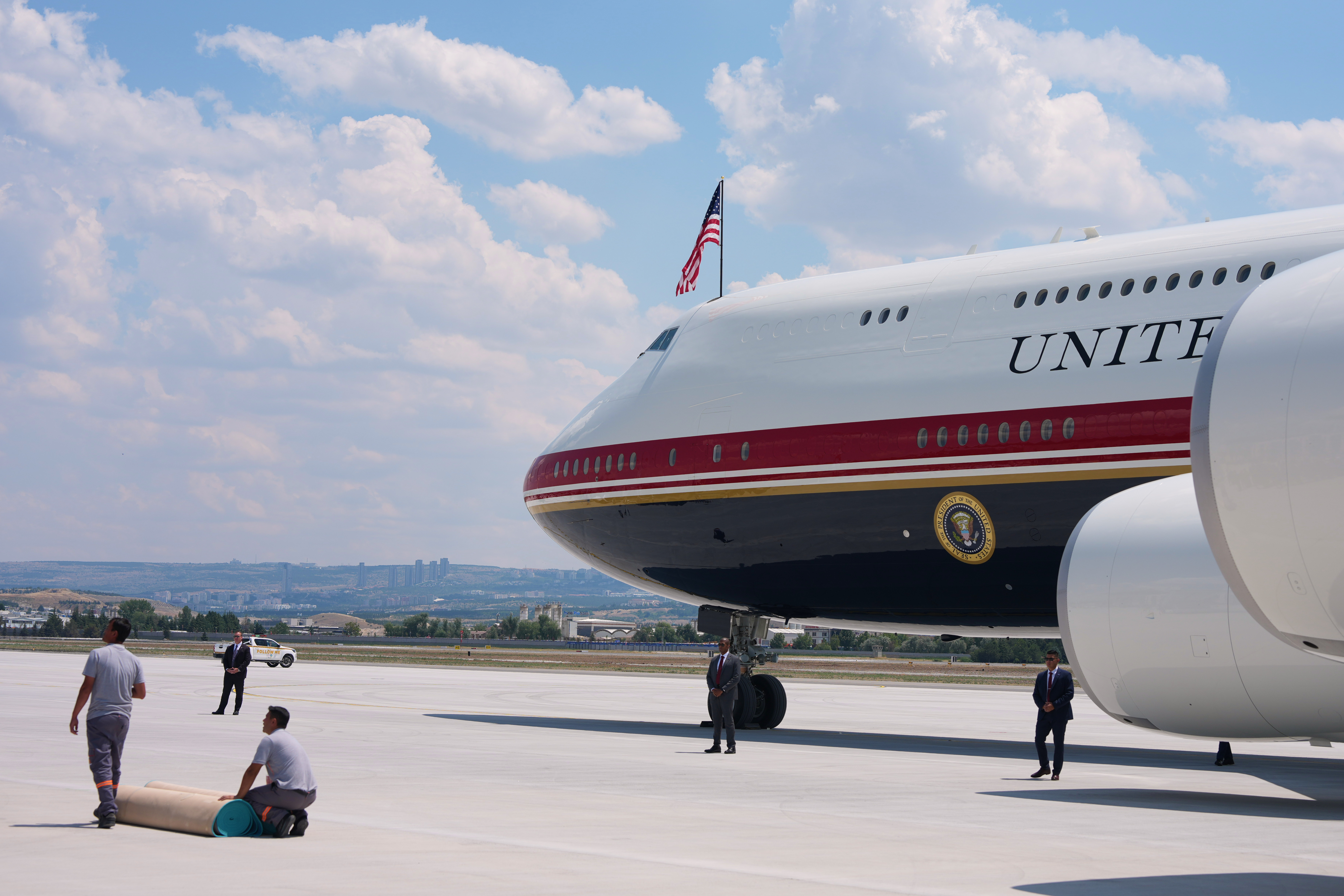 Staff lay a carpet on the tarmac before President Donald Trump exits Air Force One upon arriving for the NATO summit in Ankara, Turkey, Tuesday, July 7, 2026. 
