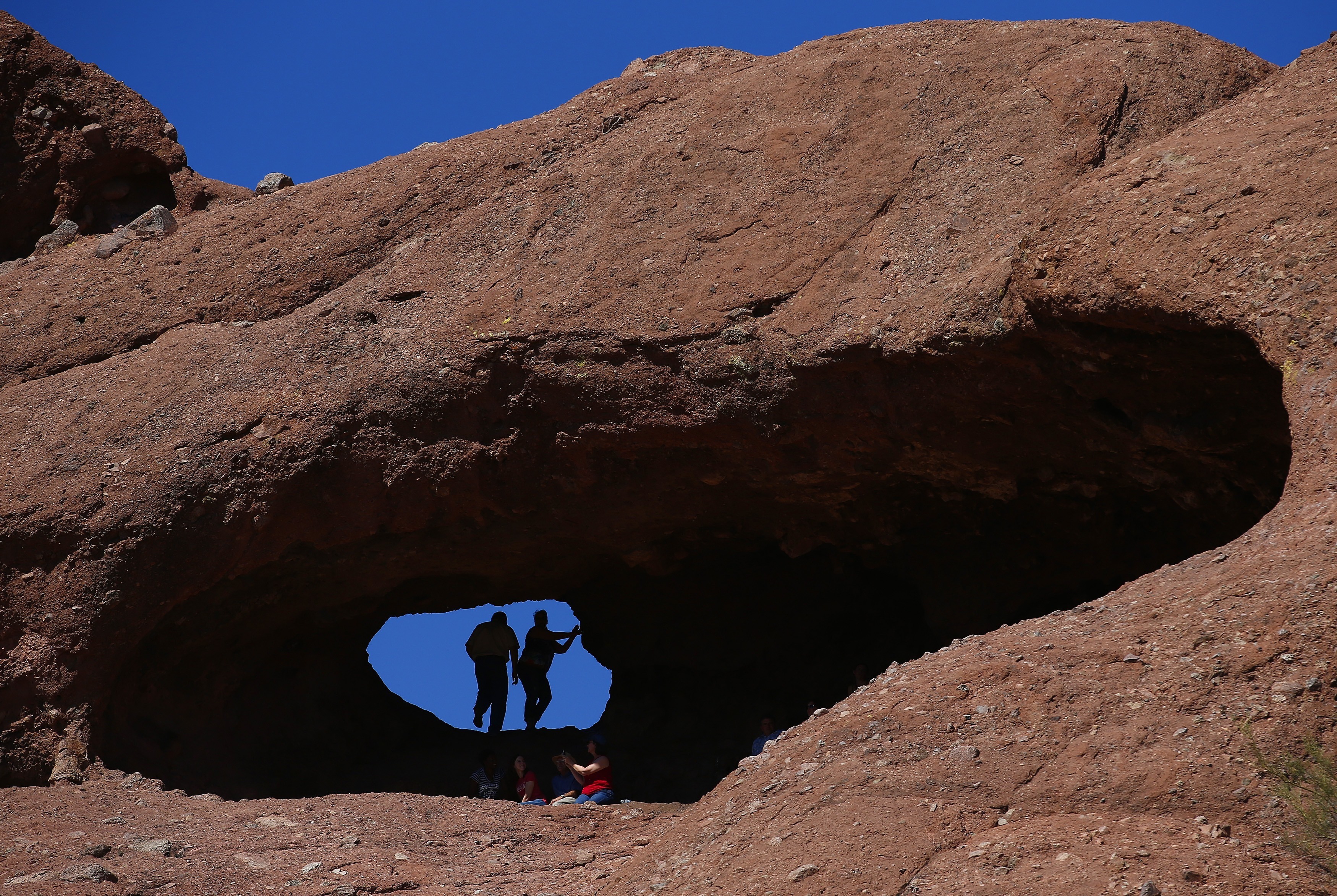 Hikers traverse the Hole-In-The-Rock Trail | Papago Park in Phoenix 