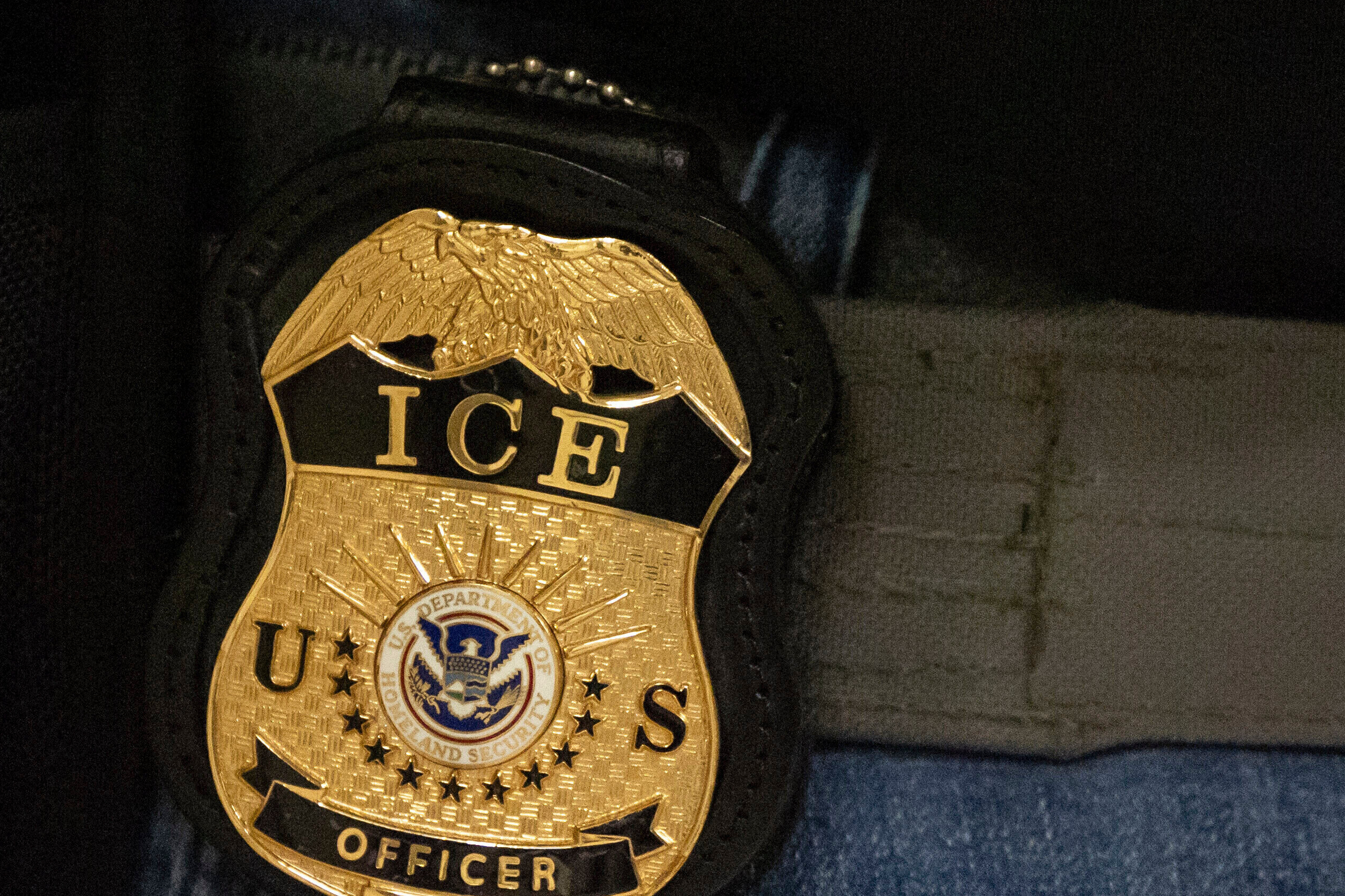 FILE - A federal agent wears an Immigration and Customs Enforcement badge.