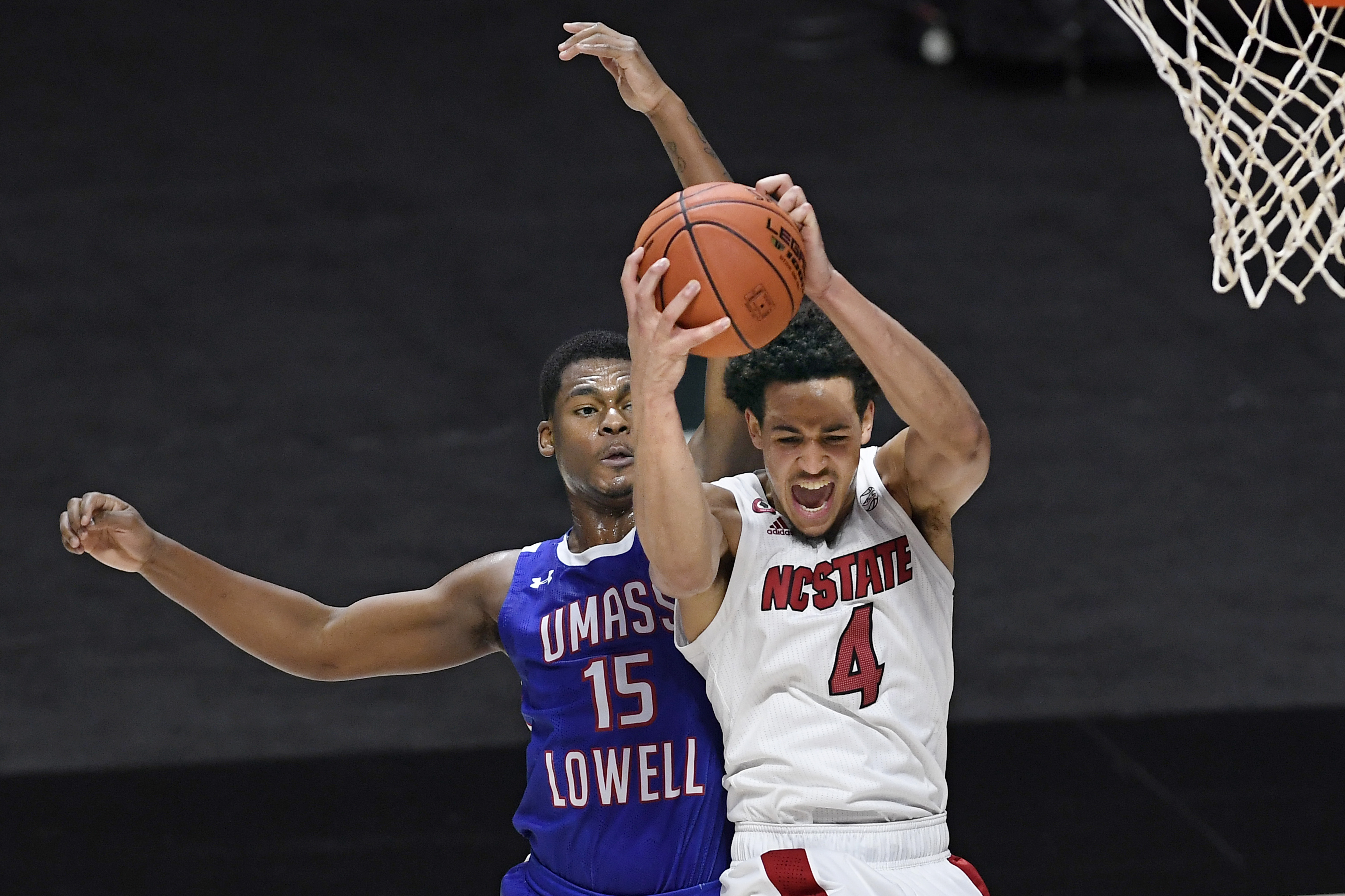 NC State Wolfpack Jericole Hellems pulls down rebound vs. UMass Lowell in 2020