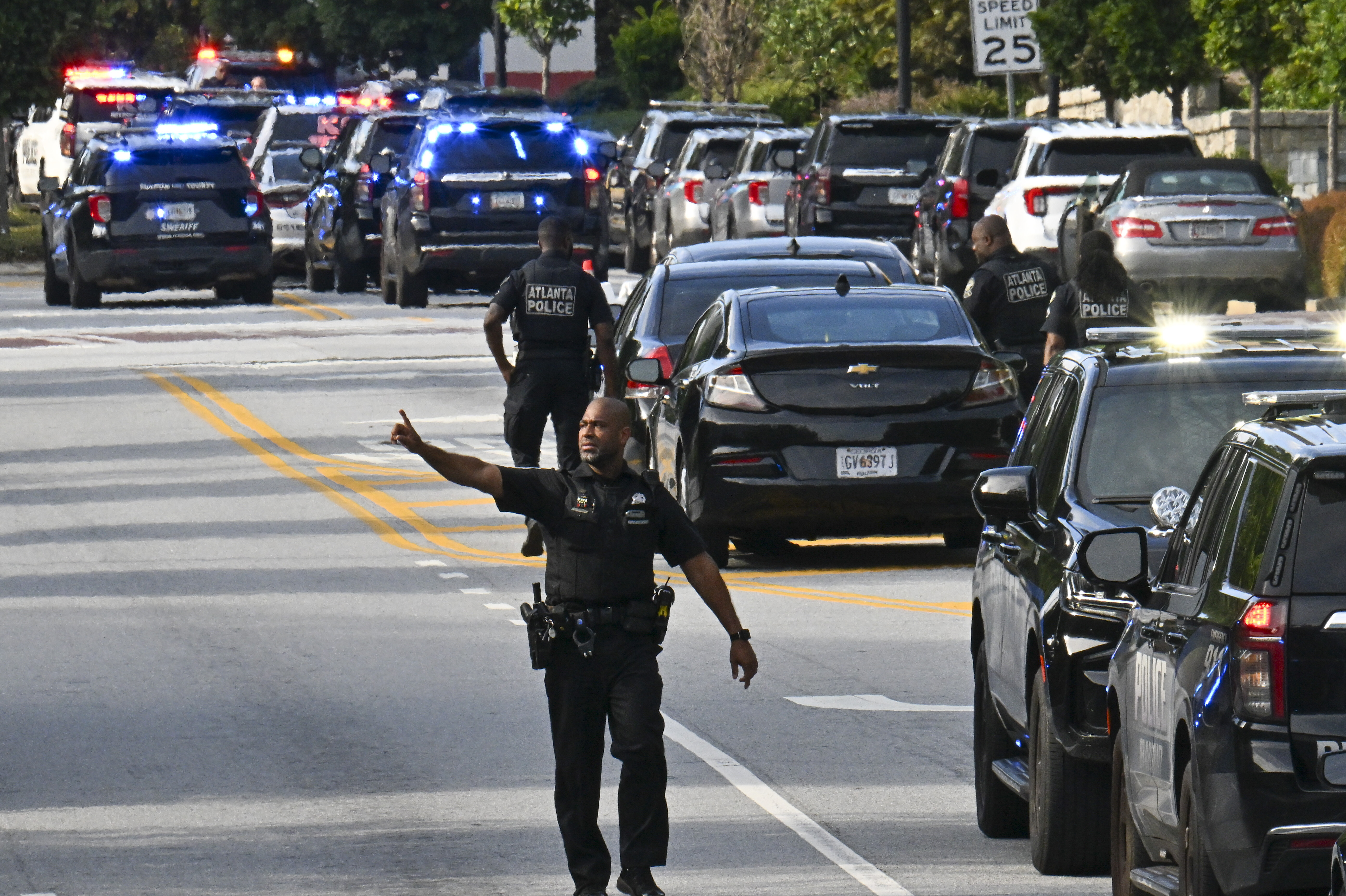 Police officers block Clifton Road near Emory Hospital as they respond to a shooting near the campuses of the U.S. Centers for Disease Control and Prevention and Emory University, Friday, Aug. 8, 2025