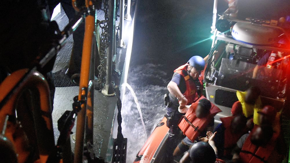 The U.S. Coast Guard says it took into custody 11 migrants and two suspected smugglers off the coast of Miami.
