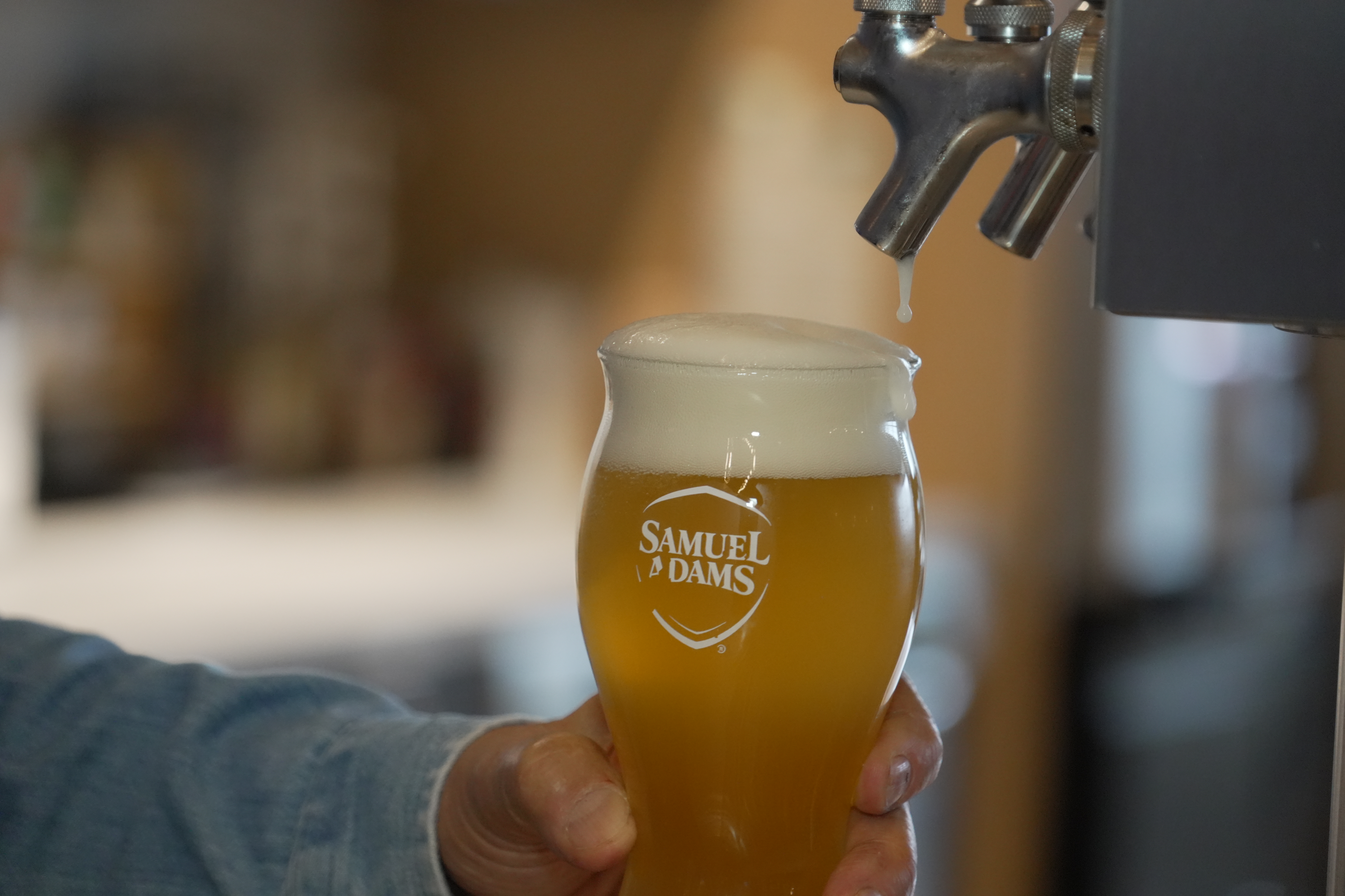 Beer froths after Boston Beer Co. Founder and CEO Jim Koch poured himself a drink at his company headquarters in Boston, Tuesday, July 7, 2026. 