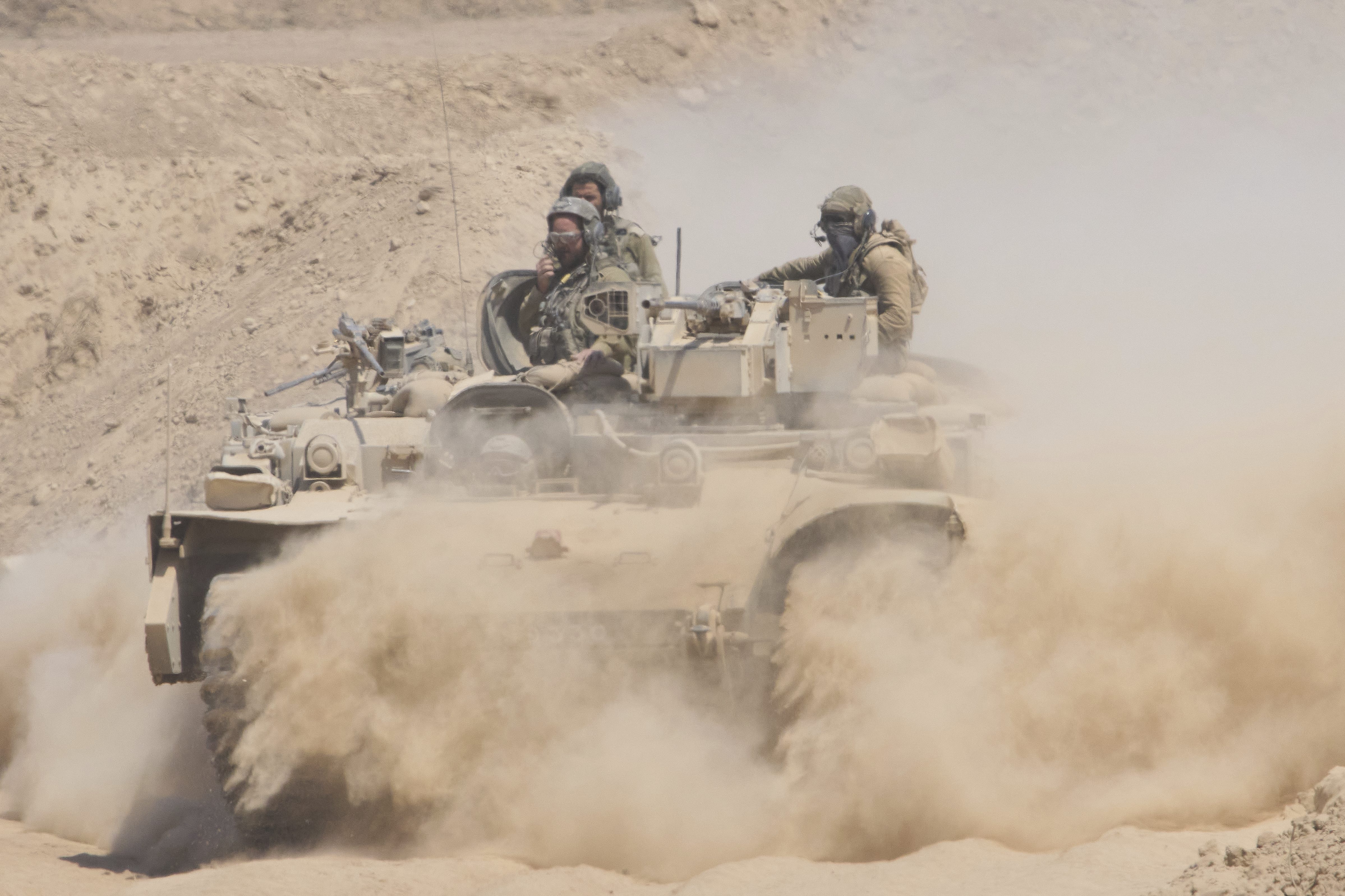 Israeli soldiers drive on their armored personnel carrier back from inside the northern Gaza Strip into southern Israel, Tuesday, July 29, 2025. 