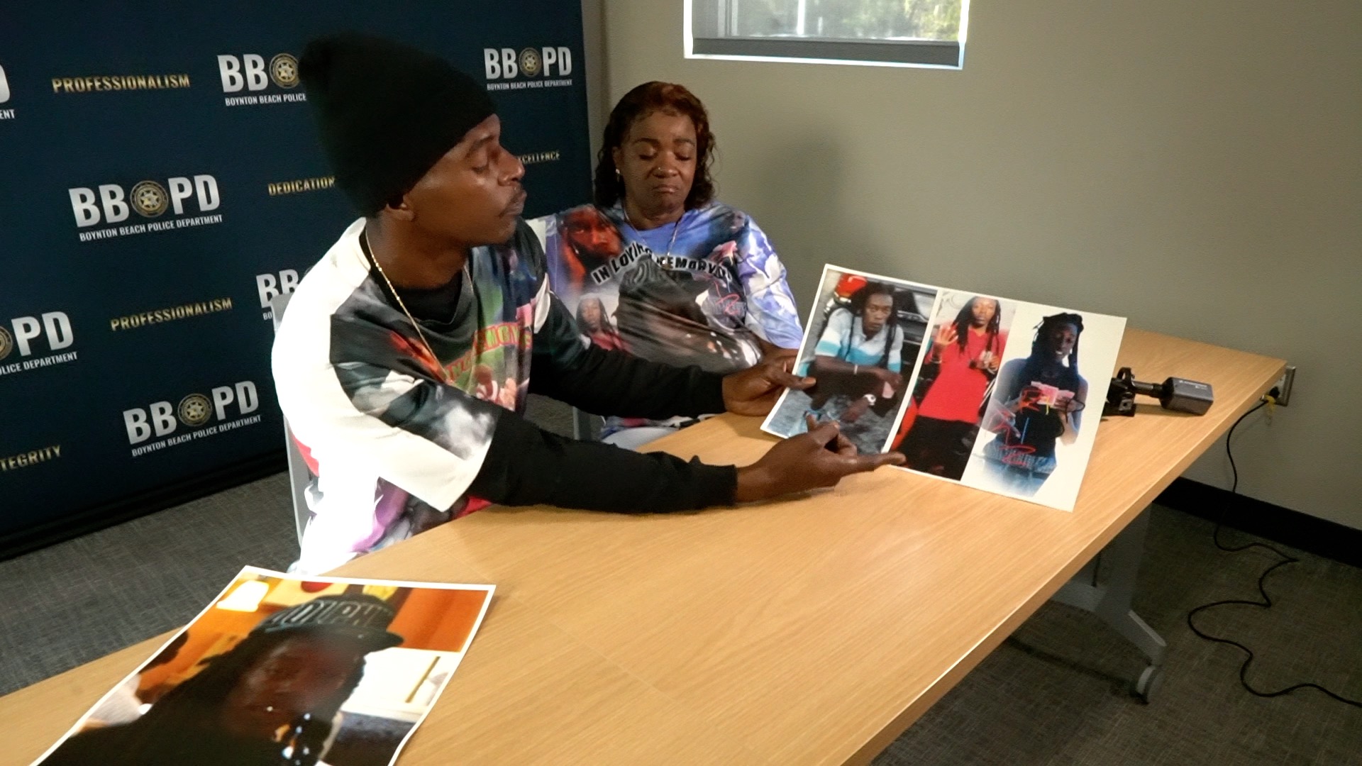 Brother and mother of Edward Morton hold pictures of him, Feb. 4, 2021