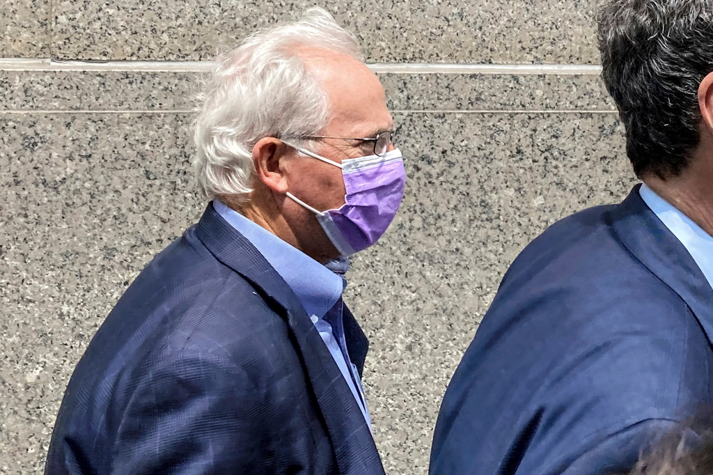 FILE — Former U.S. Rep. Stephen Buyer, left, trails his lawyer as he leaves Manhattan federal court after pleading not guilty to charges that he participated in an insider trading scheme while working as a consultant, July 27, 2022, in New York.