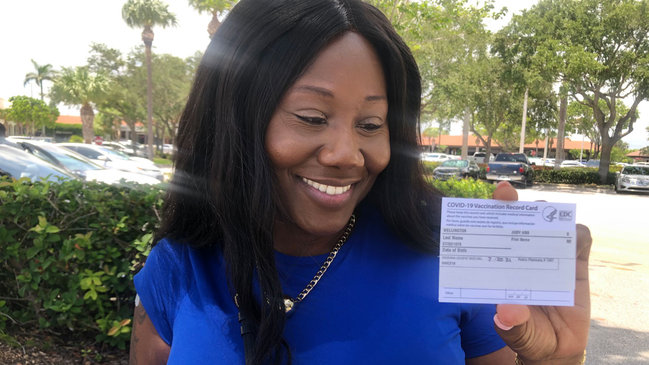Nurse Judy-Ann Wellington shows off COVID-19 vaccine card on July 22, 2021